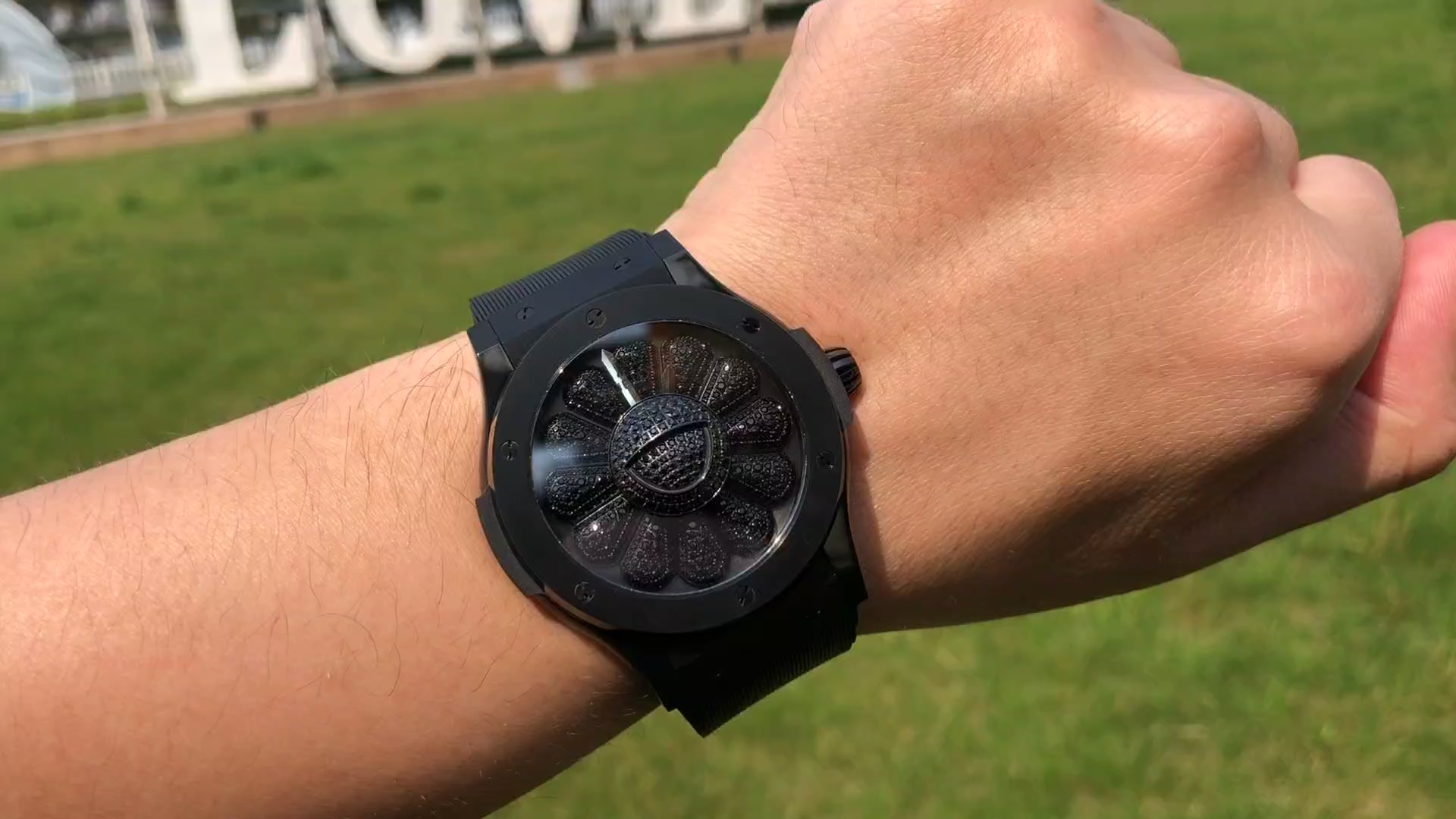 Wrist shot of Hublot Classic Fusion 507.CX.9000.RX.TAK21 showing black case on outdoor wrist. - Video