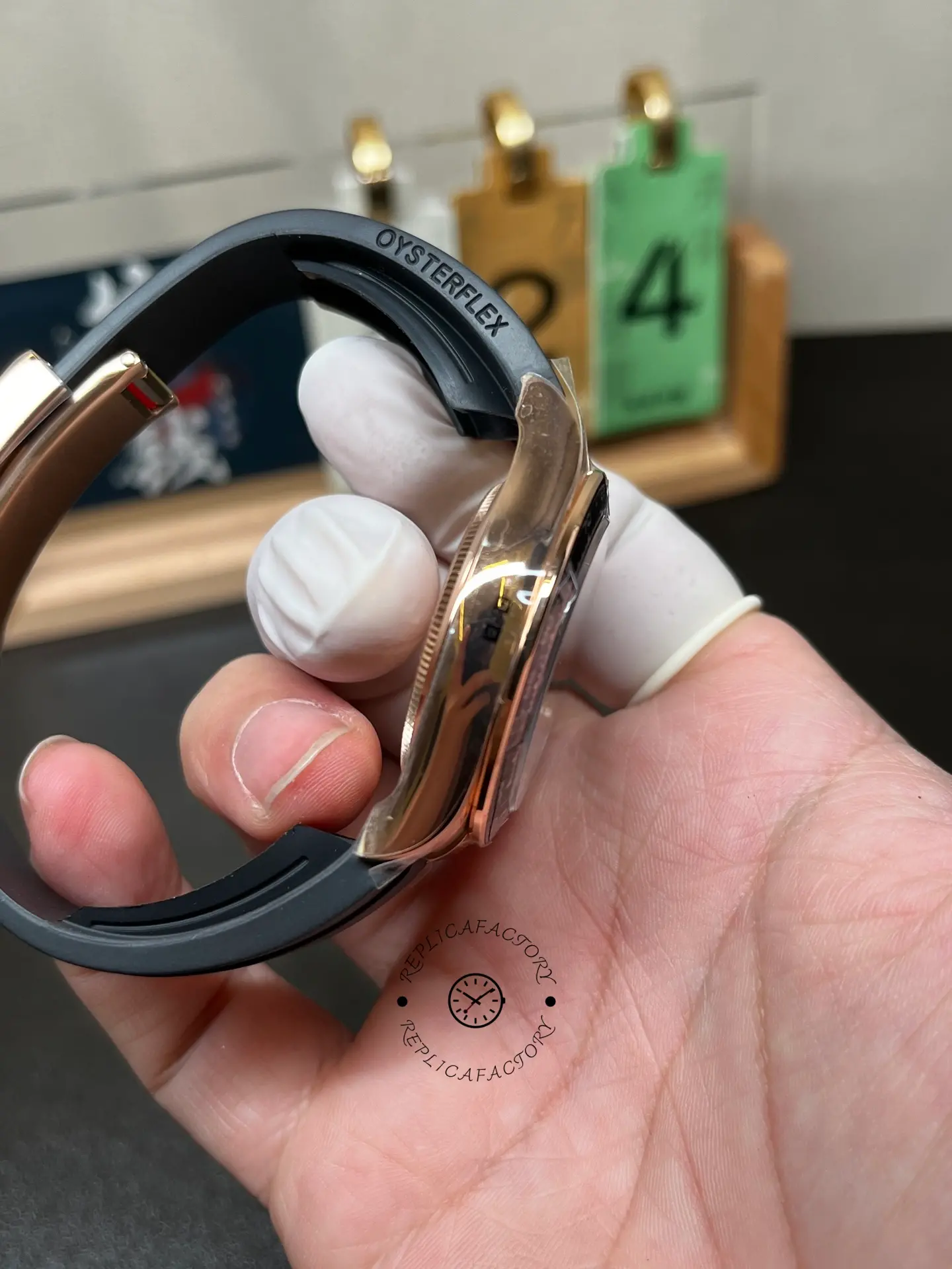 Side profile of Rolex 126515LN-0010 with black Oysterflex strap and polished rose gold-style case flank.