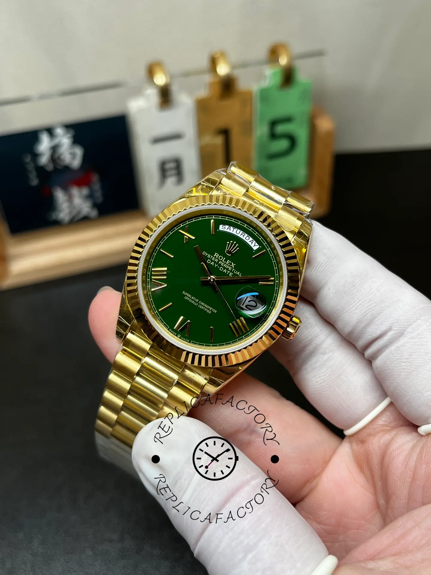 Three-quarter handheld view of Rolex 228238-0061 with green dial and President bracelet.