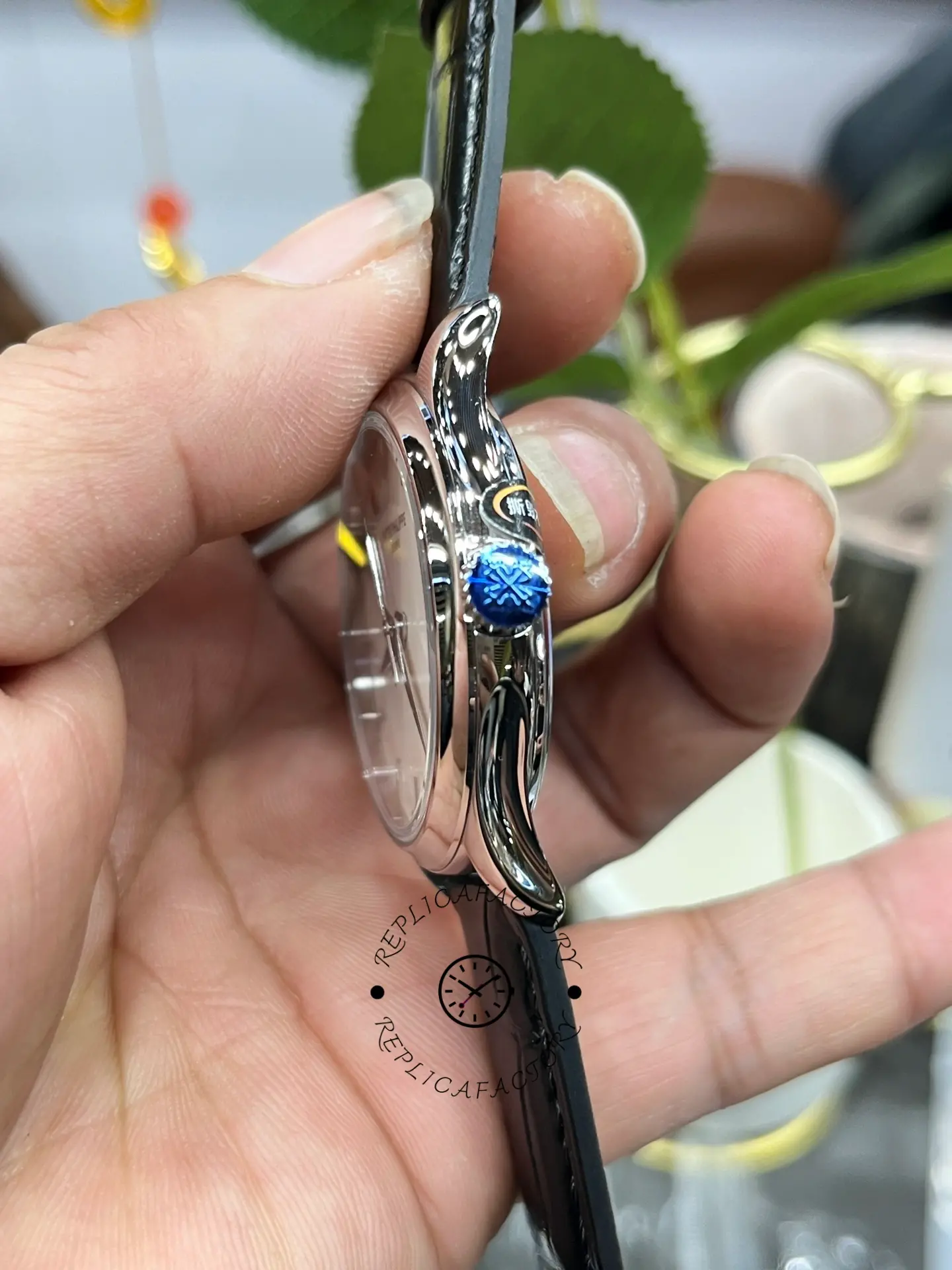 Side angle of the Patek Philippe Calatrava 5227G-001 highlighting the crown and polished case flank.