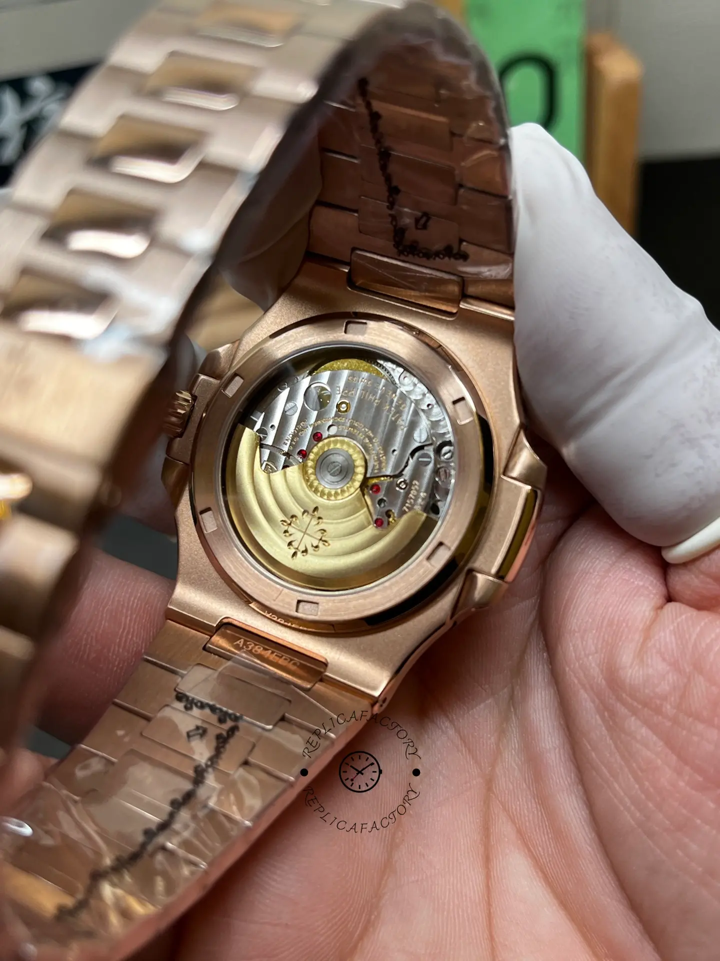 Caseback view of Patek Philippe Nautilus 5711/1R-001 showing gold rotor and movement through sapphire.