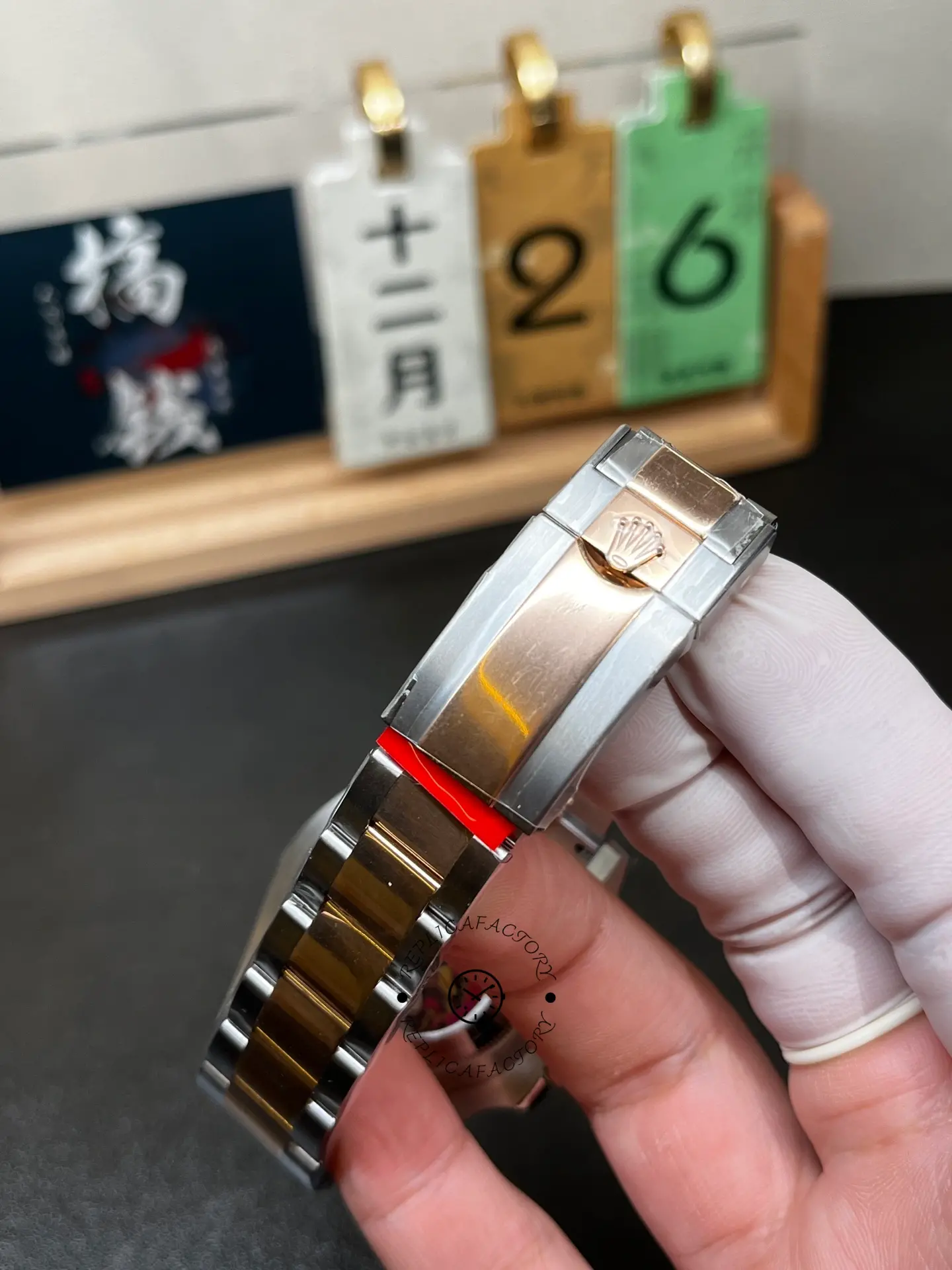 Close-up of Rolex 126711CHNR clasp showing brushed and polished two-tone clasp with crown logo.