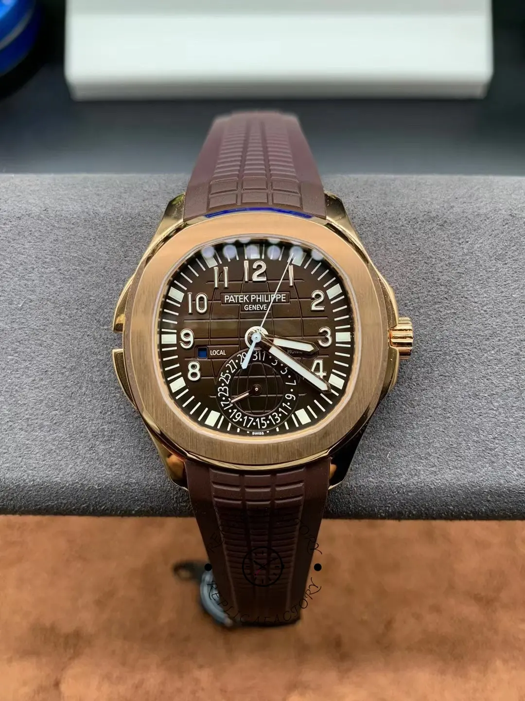 Full watch view of the Patek Philippe Aquanaut 5164R-001 on wrist, showing rose-gold case and brown dial.