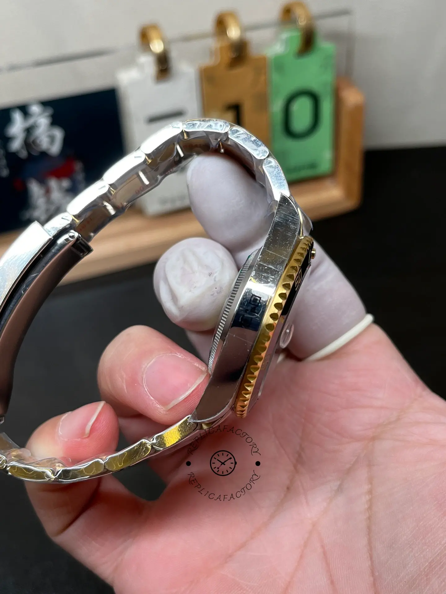 Opposite side view of Rolex Submariner 126613LN-0002 replica showing case side and gold-tone bezel edge.