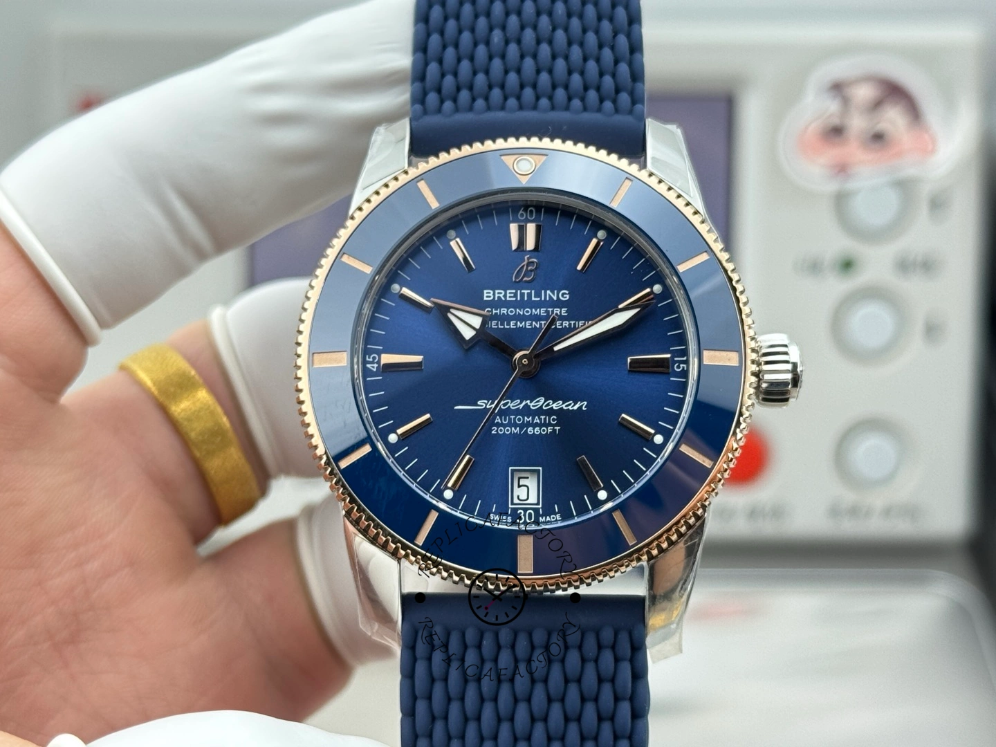UB3112161C1S1 full dial view, blue sunburst dial with date window and rose-gold tone markers on blue strap.
