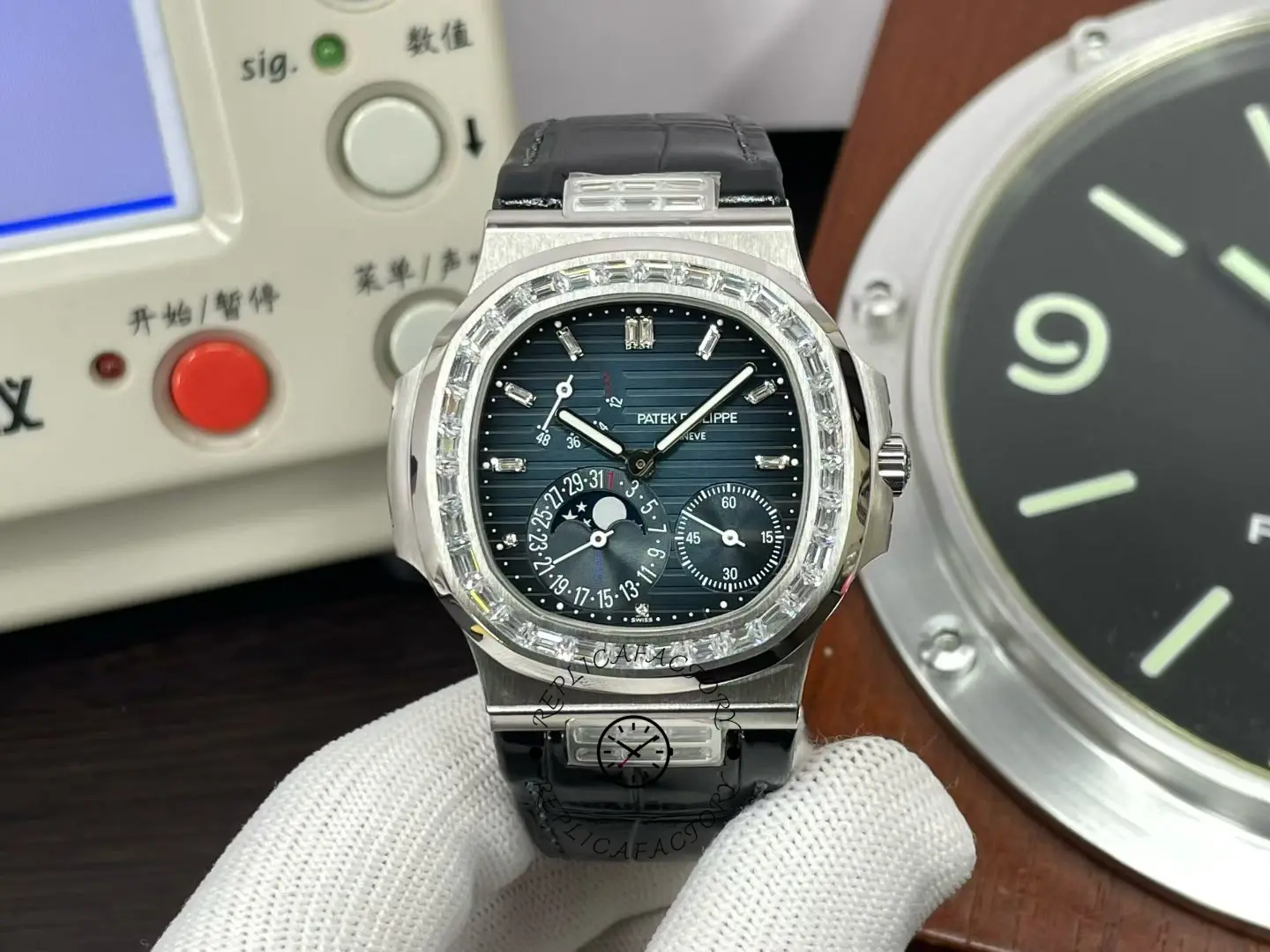 Straight-on view of Patek Philippe Nautilus 5724G 001 with black dial and diamond bezel.