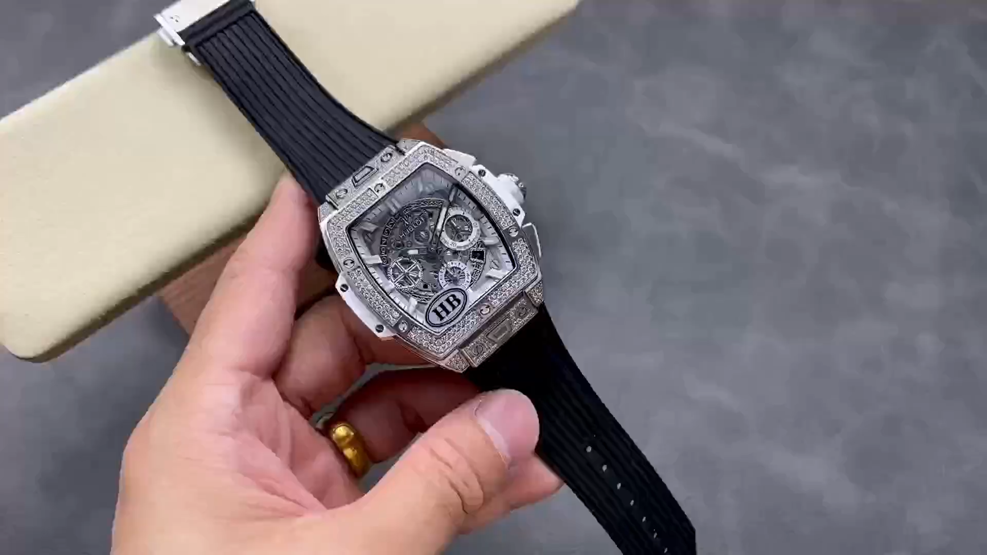 Strap in hand close-up of Hublot Spirit of Big Bang 642.NE.2010.RW.1604 showing black strap texture. - Video