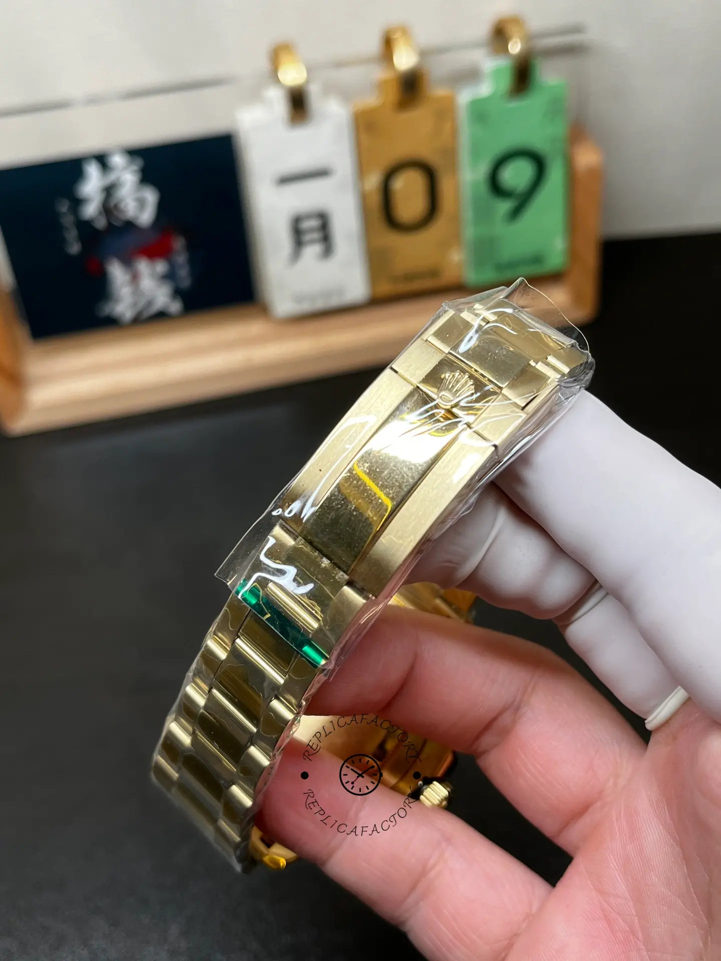 Clasp close-up of Rolex Yacht-Master II 116688 showing engraved crown logo on gold-tone bracelet.
