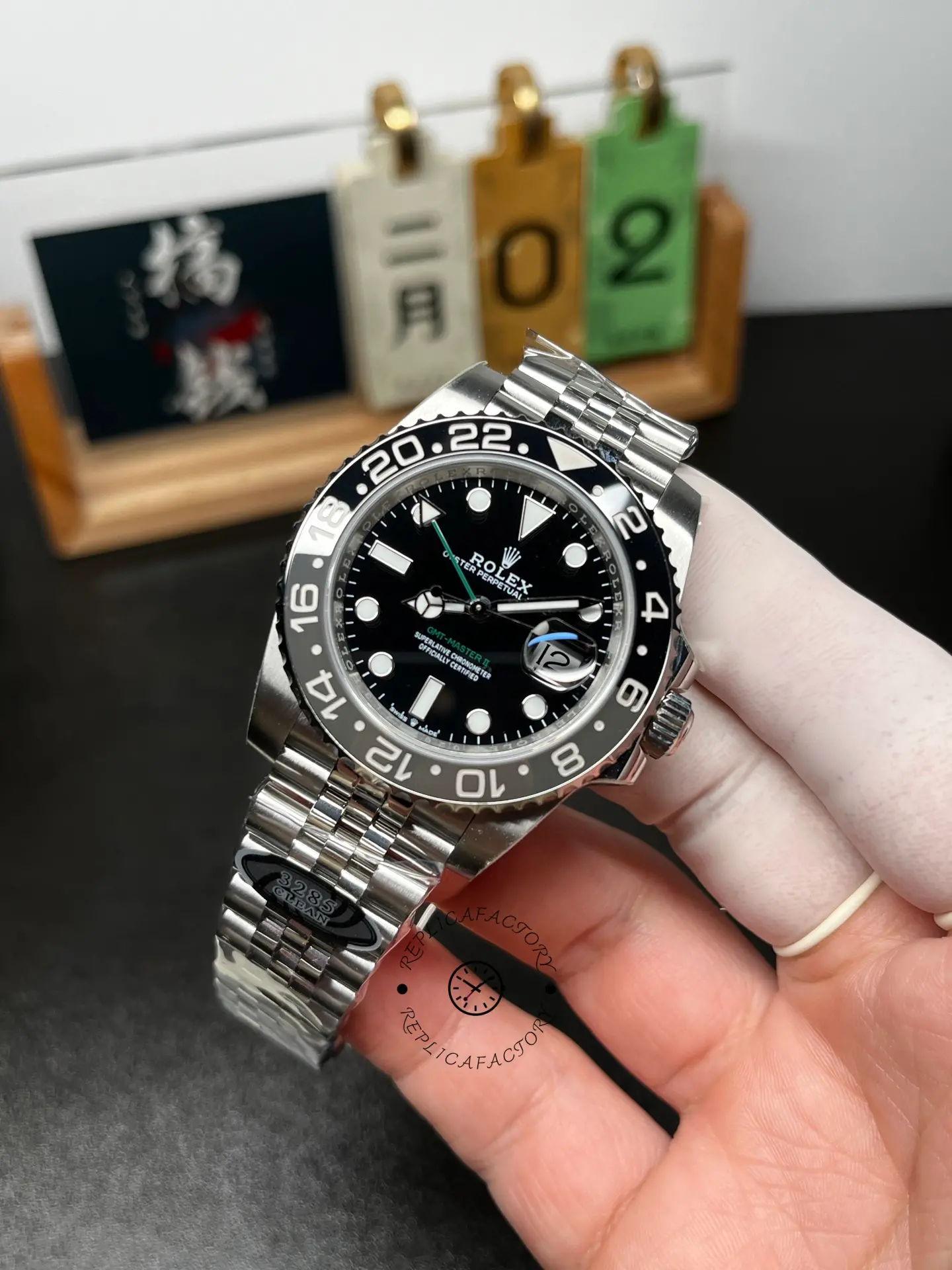 Full shot of Rolex GMT-Master II M126710GRNR-0003 showing black/grey bezel and Jubilee bracelet.