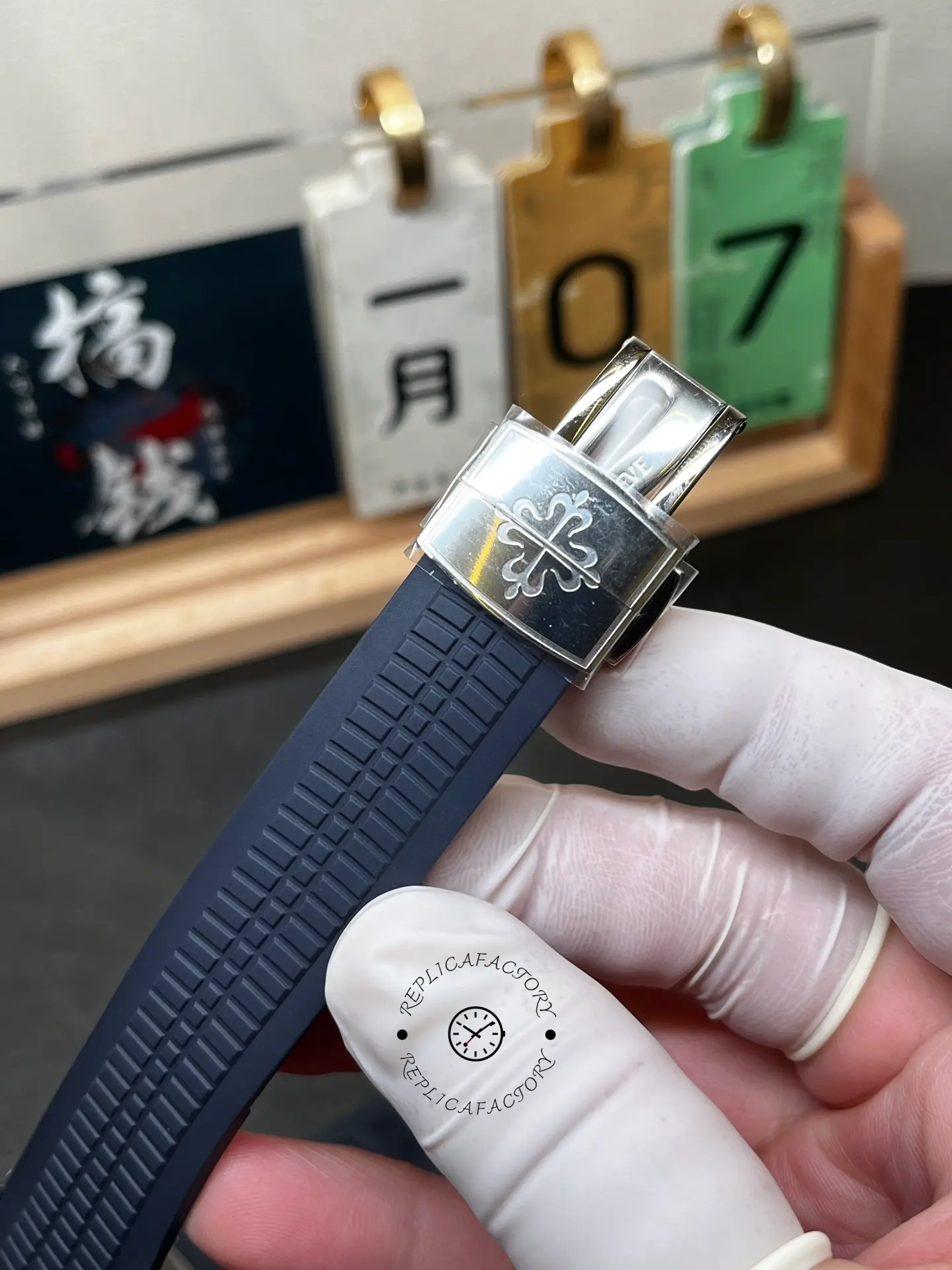 Deployant clasp detail of Patek Philippe Aquanaut 5168G-001 showing clasp mechanism and logo.