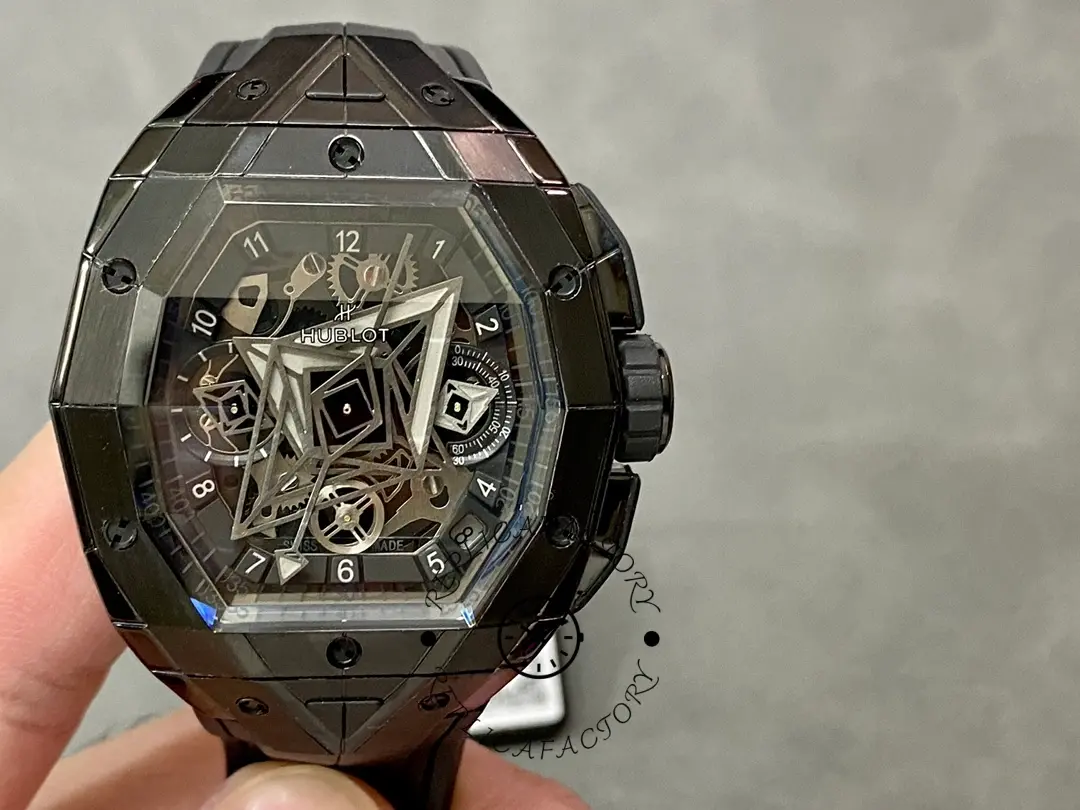In-hand dial view of Hublot 648.CX.0114.RX.MXM23 showing skeleton subdials, minute track, and black crown.