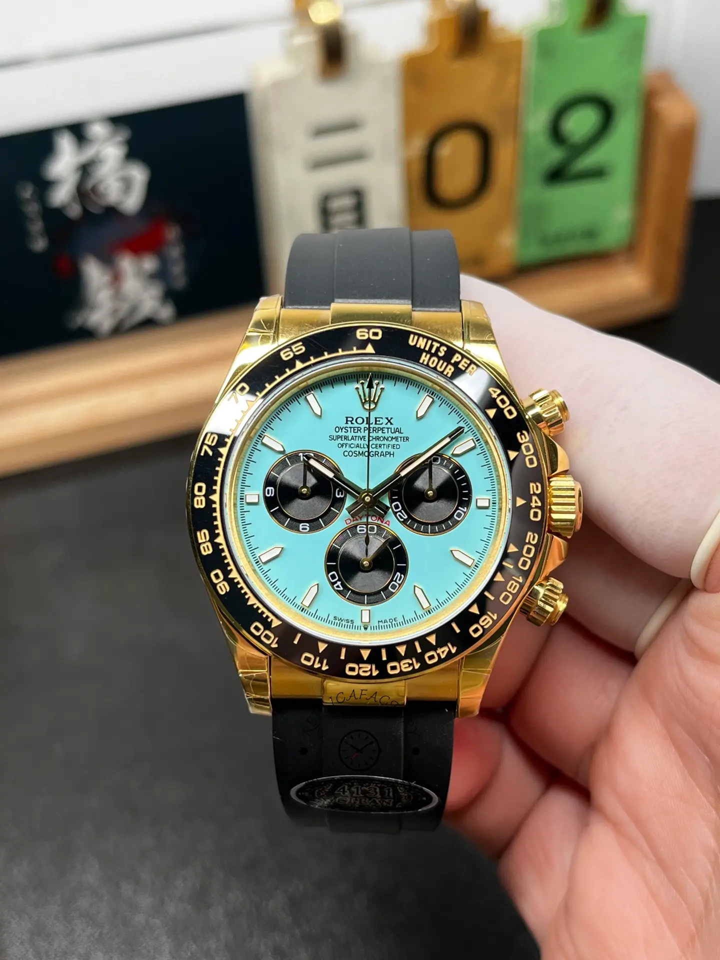 Front view of Rolex Daytona 126518LN-0014 with turquoise dial, black subdials, and black tachymeter bezel.