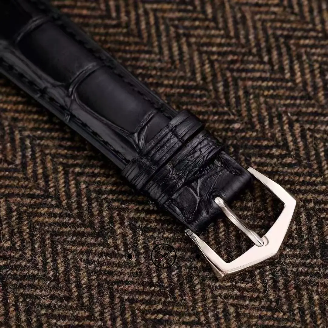 Strap and buckle detail of the Patek Philippe Calatrava 5227G-001 showing stitching and tang buckle.