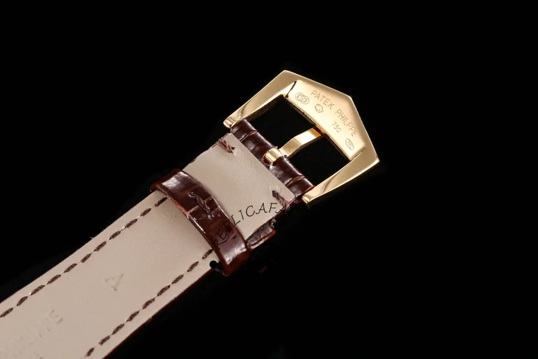 Strap and buckle close-up of the Patek Philippe 5119G-001, leather texture and pin buckle shown.