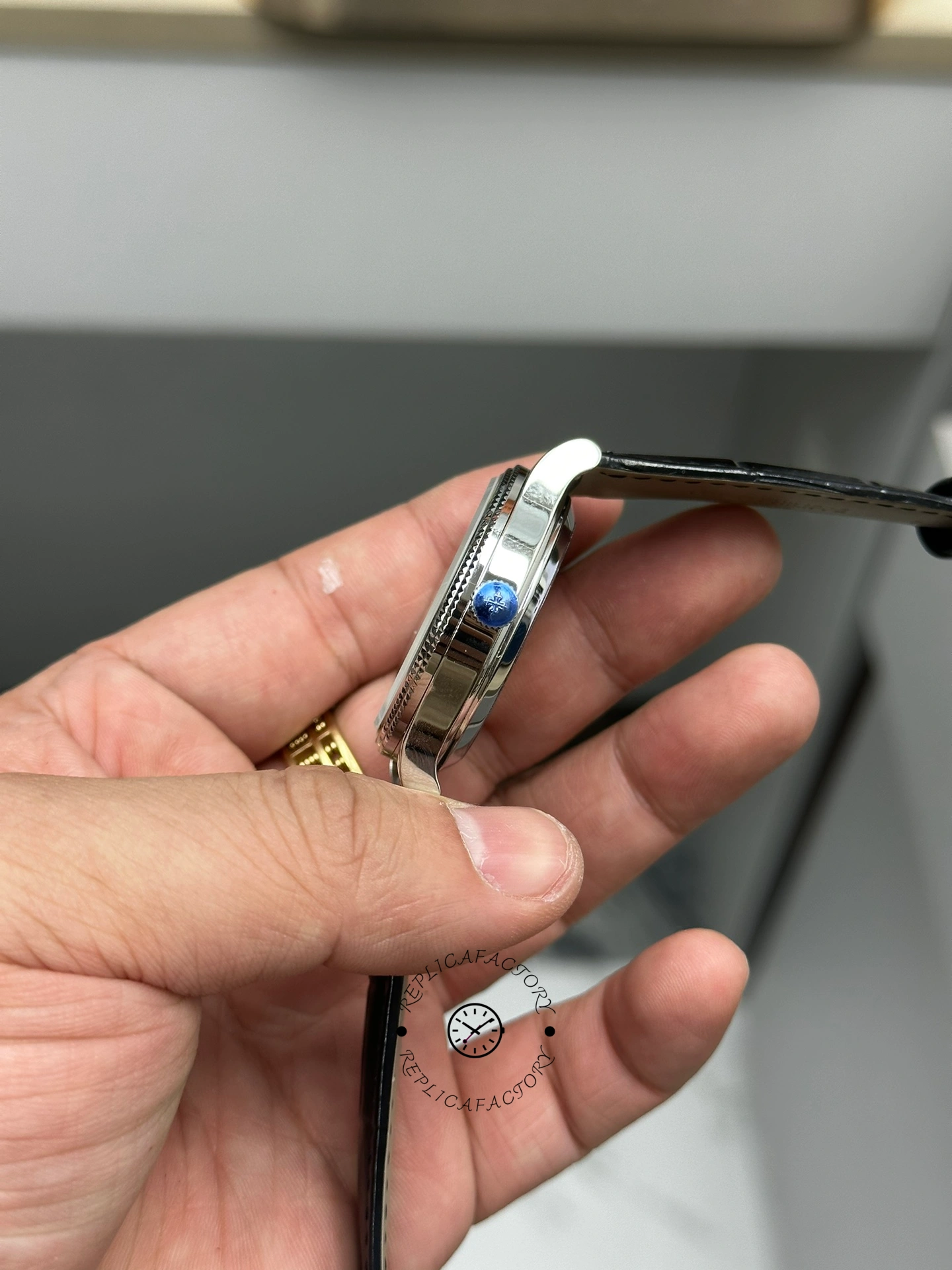 Side profile of Patek Philippe Calatrava 6119G-001 showing slim case and crown on leather strap.