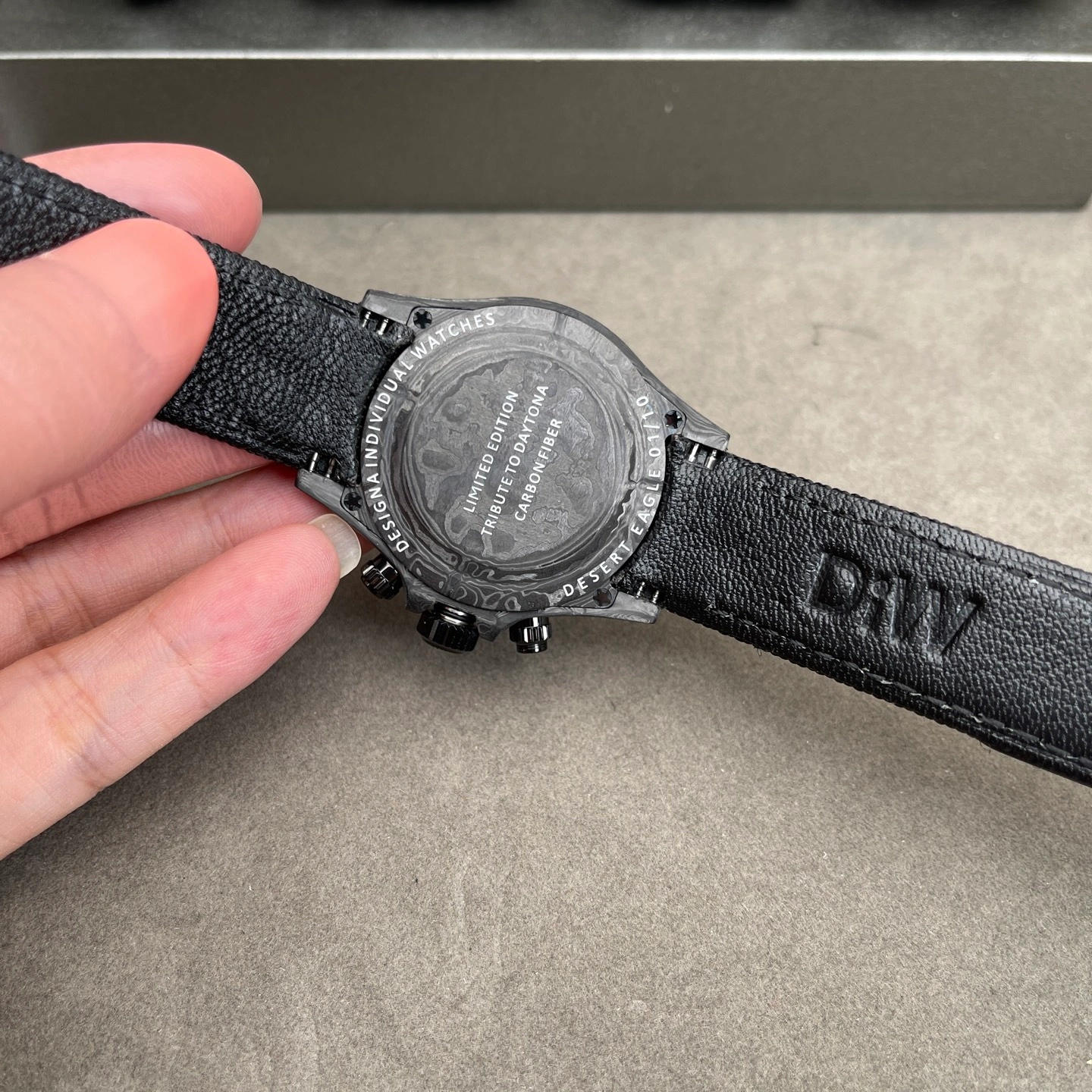 Back view of a carbon watch showing the case material pattern