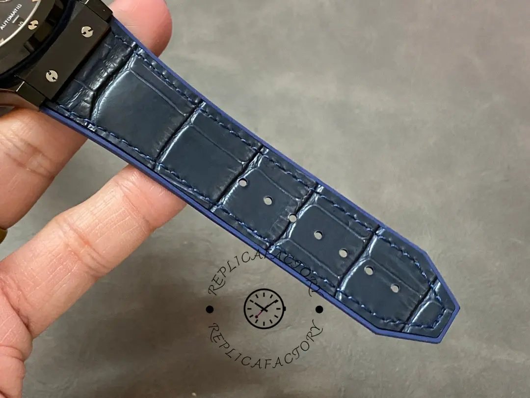 Strap tail detail of Hublot 521.CM.7170.LR showing blue leather texture and sizing holes.