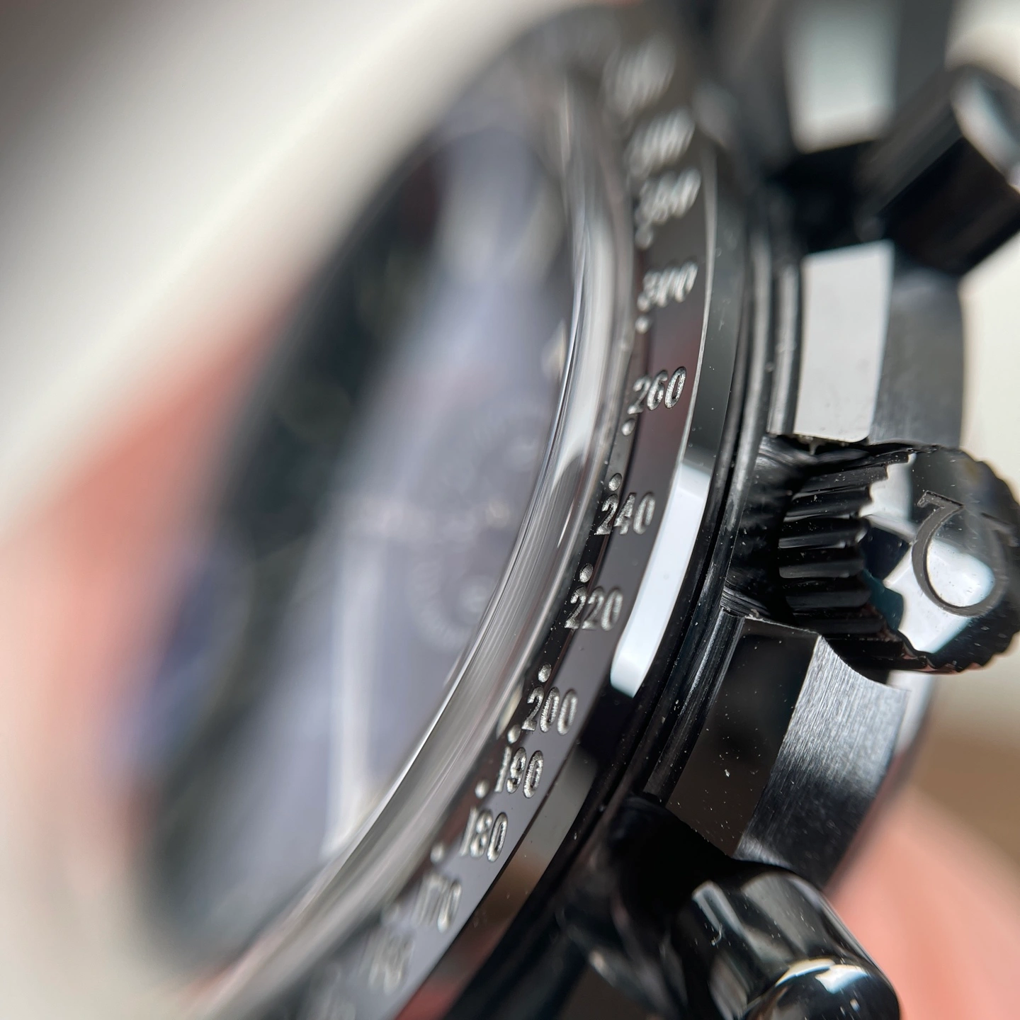 Close-up of a ceramic bezel and case side showing the surface finish