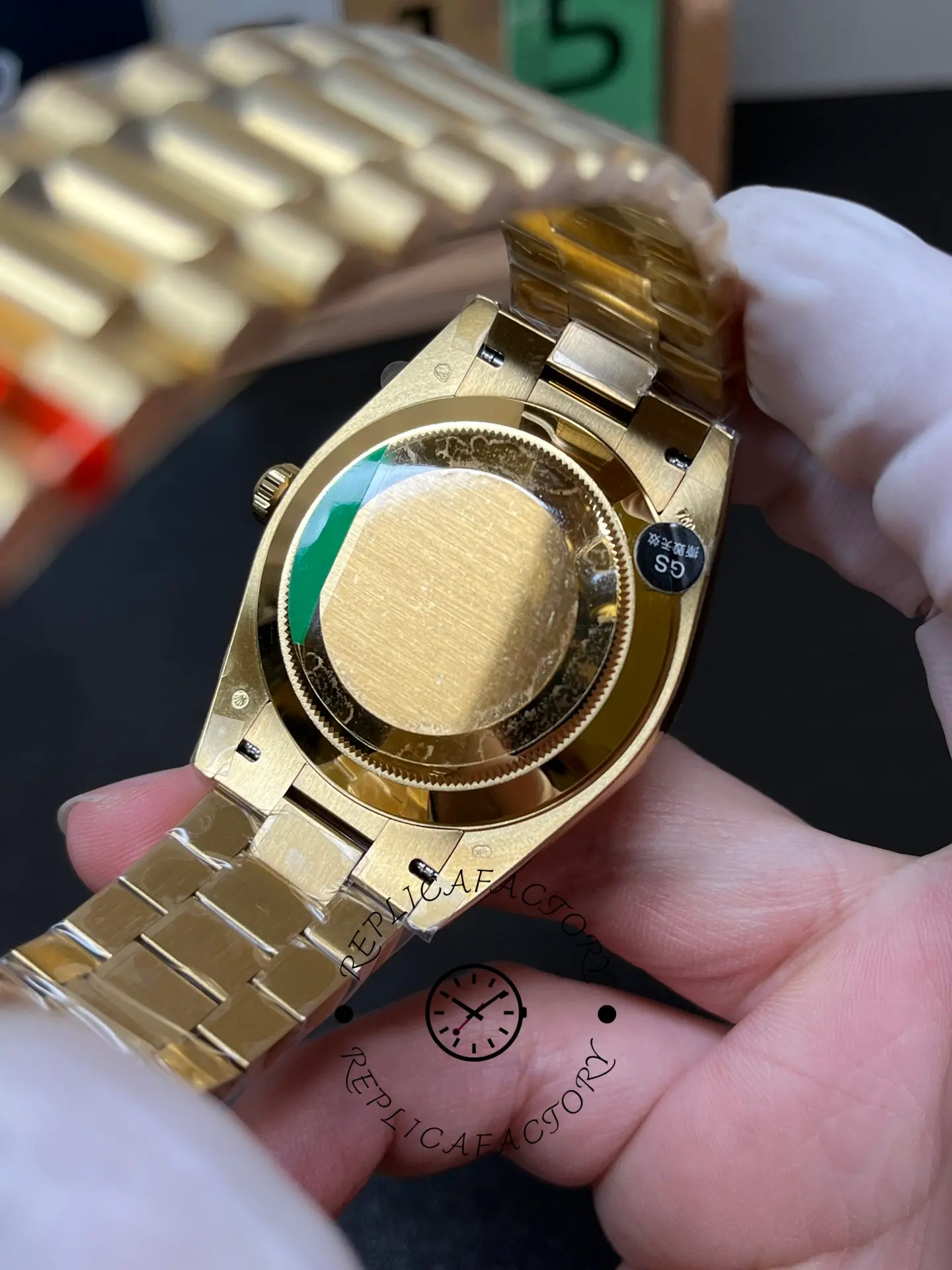 Caseback view of Rolex 228238-0061 with President bracelet opened in hand.