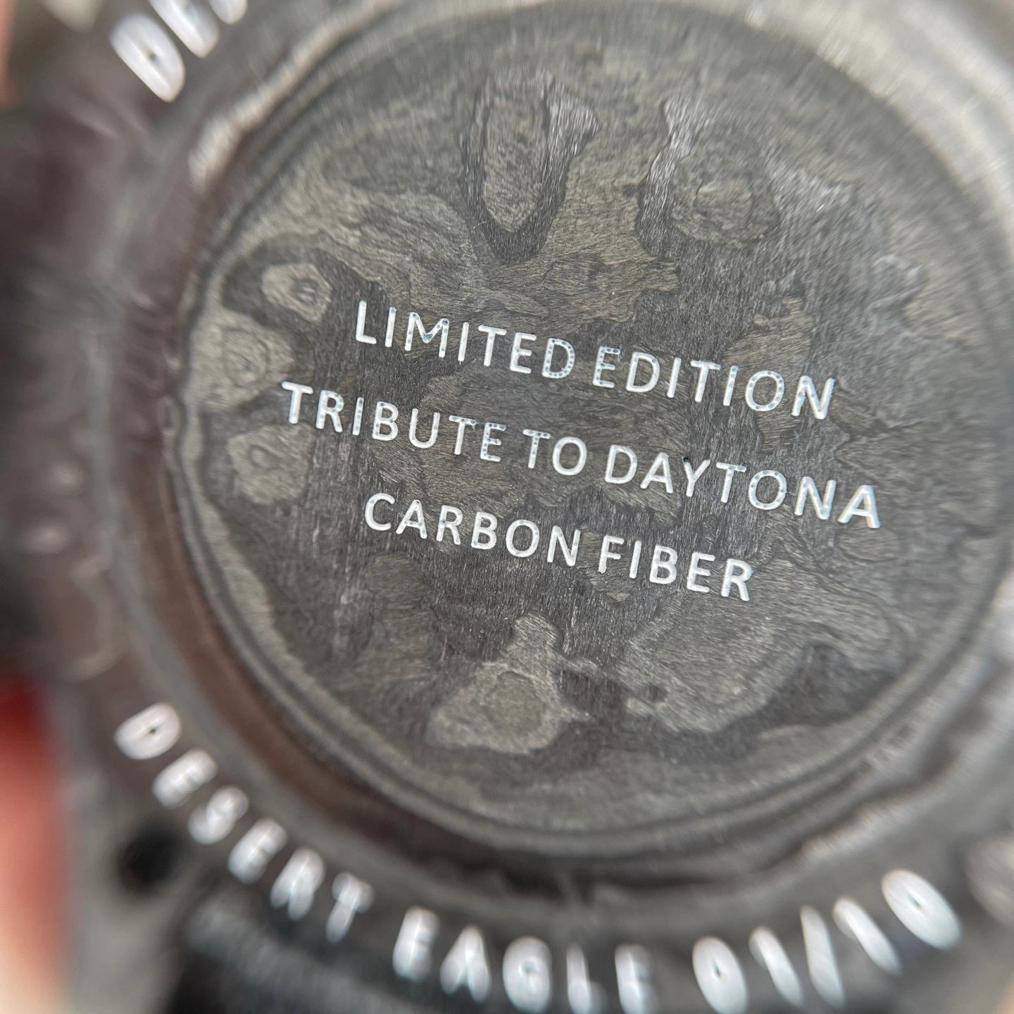 Close-up of a carbon-pattern watch dial and surface texture