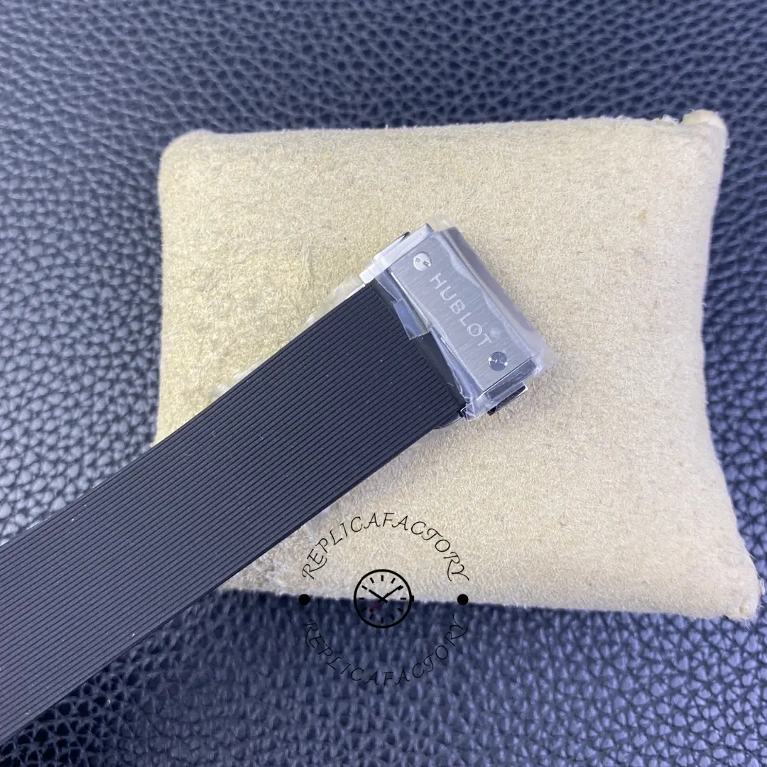 Rubber strap buckle/clasp end of Hublot Classic Fusion 511.CO.1181.RX shown on cushion.