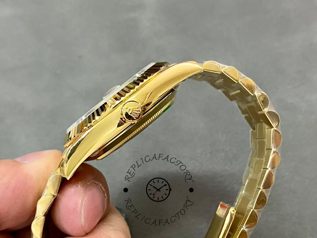 Side profile in hand of Rolex 228238-0061 showing gold crown and bracelet curve.