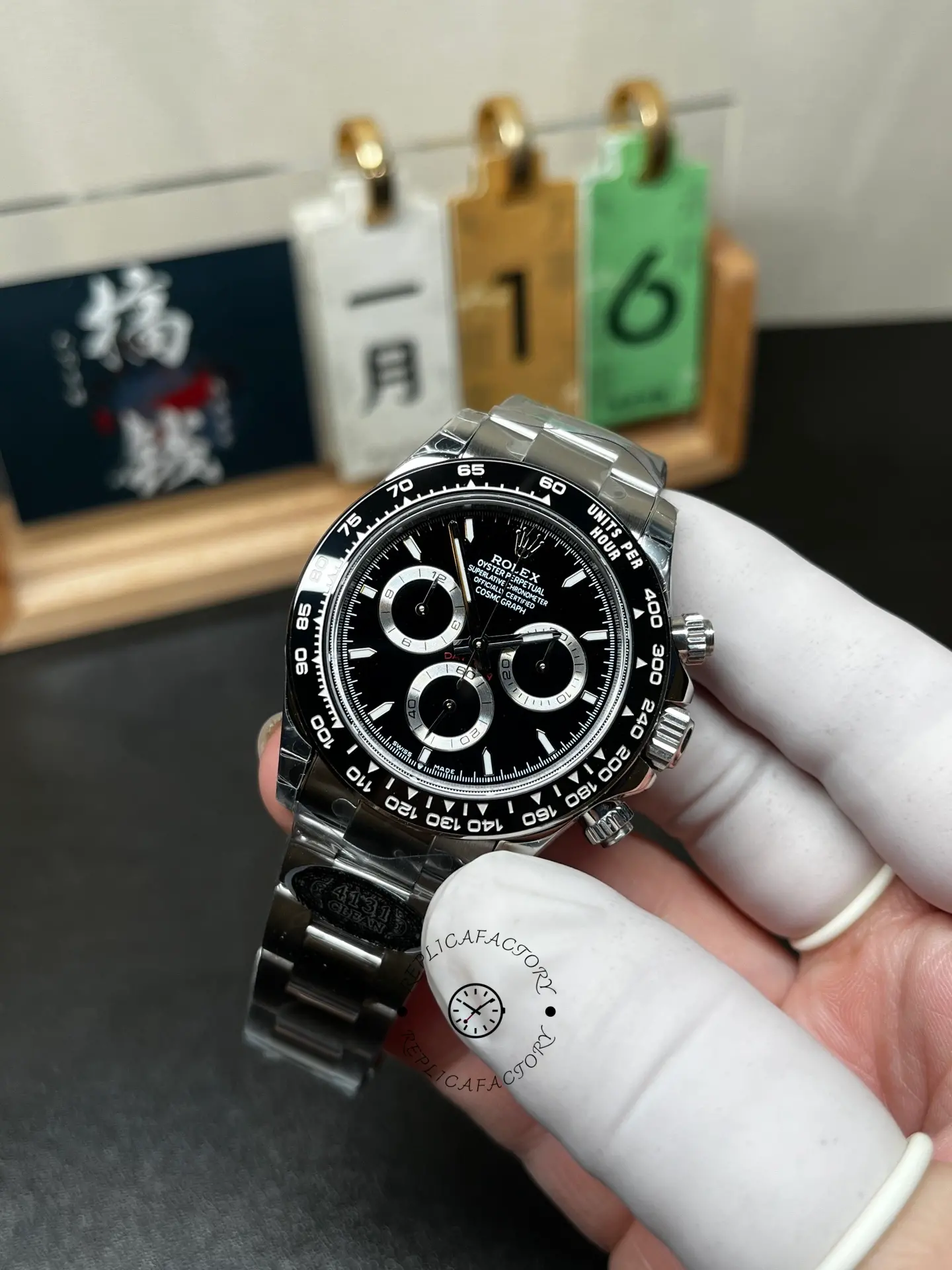 Angled front view of Rolex m126500ln-0002 with black dial and ceramic bezel held in hand.