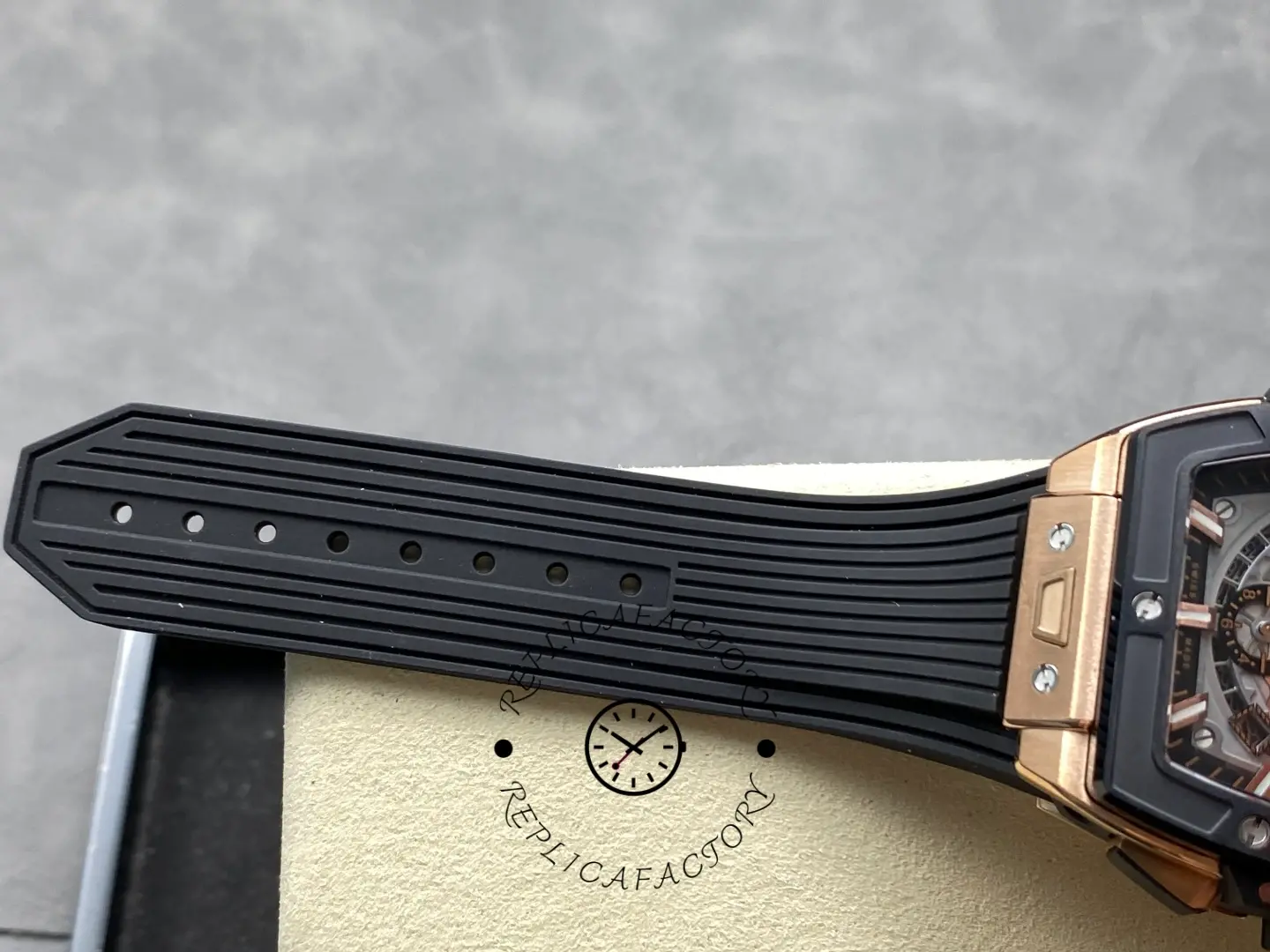 Strap holes detail of Hublot 642.OM.0180.RX showing sizing holes and ribbed rubber texture.