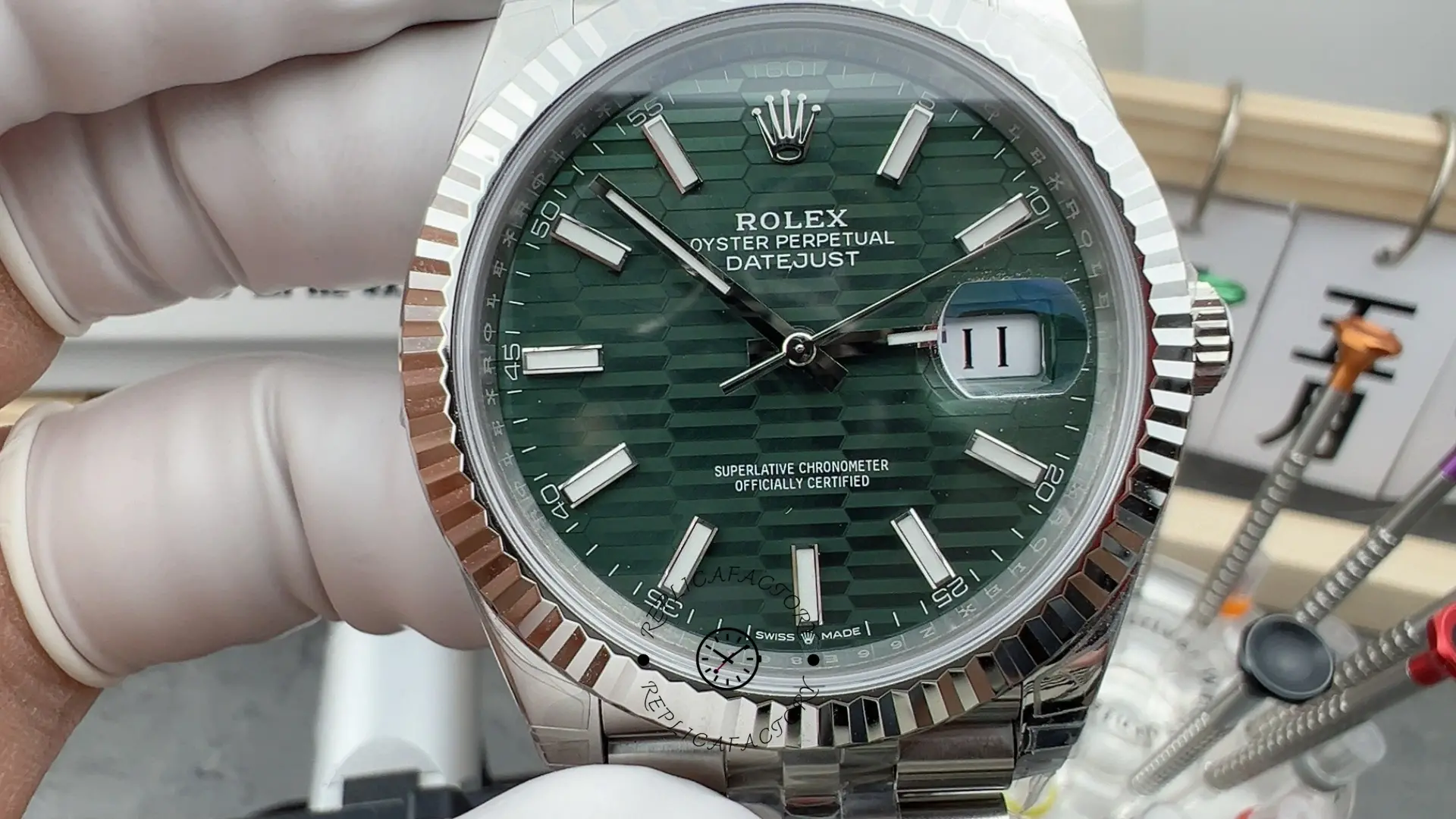 Close front view of Rolex Datejust 41 126334-0030 showing mint green motif dial and date magnifier.