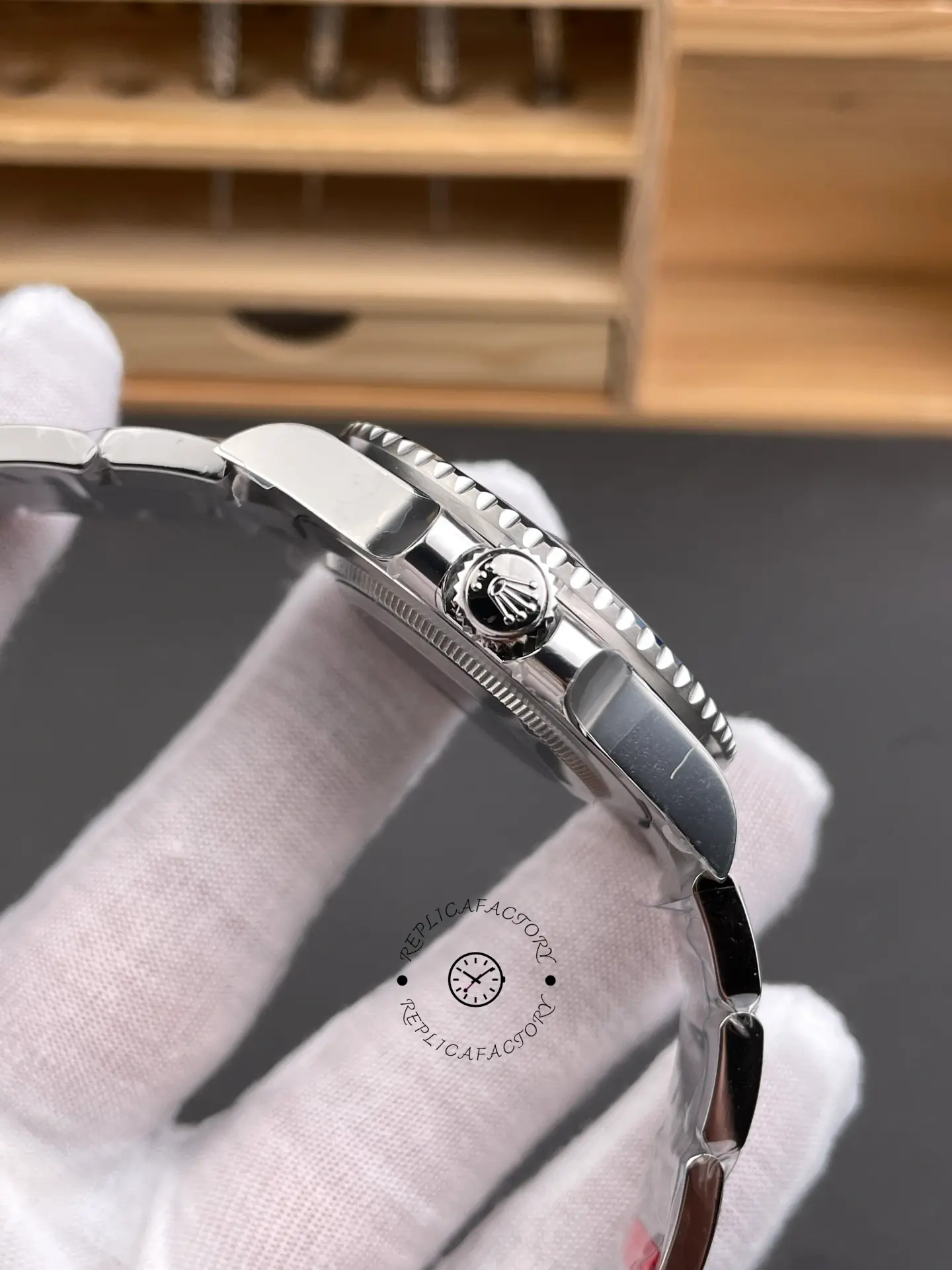 Side profile of Rolex GMT-Master II 116710BLNR showing crown guards, signed crown, and bezel edge.