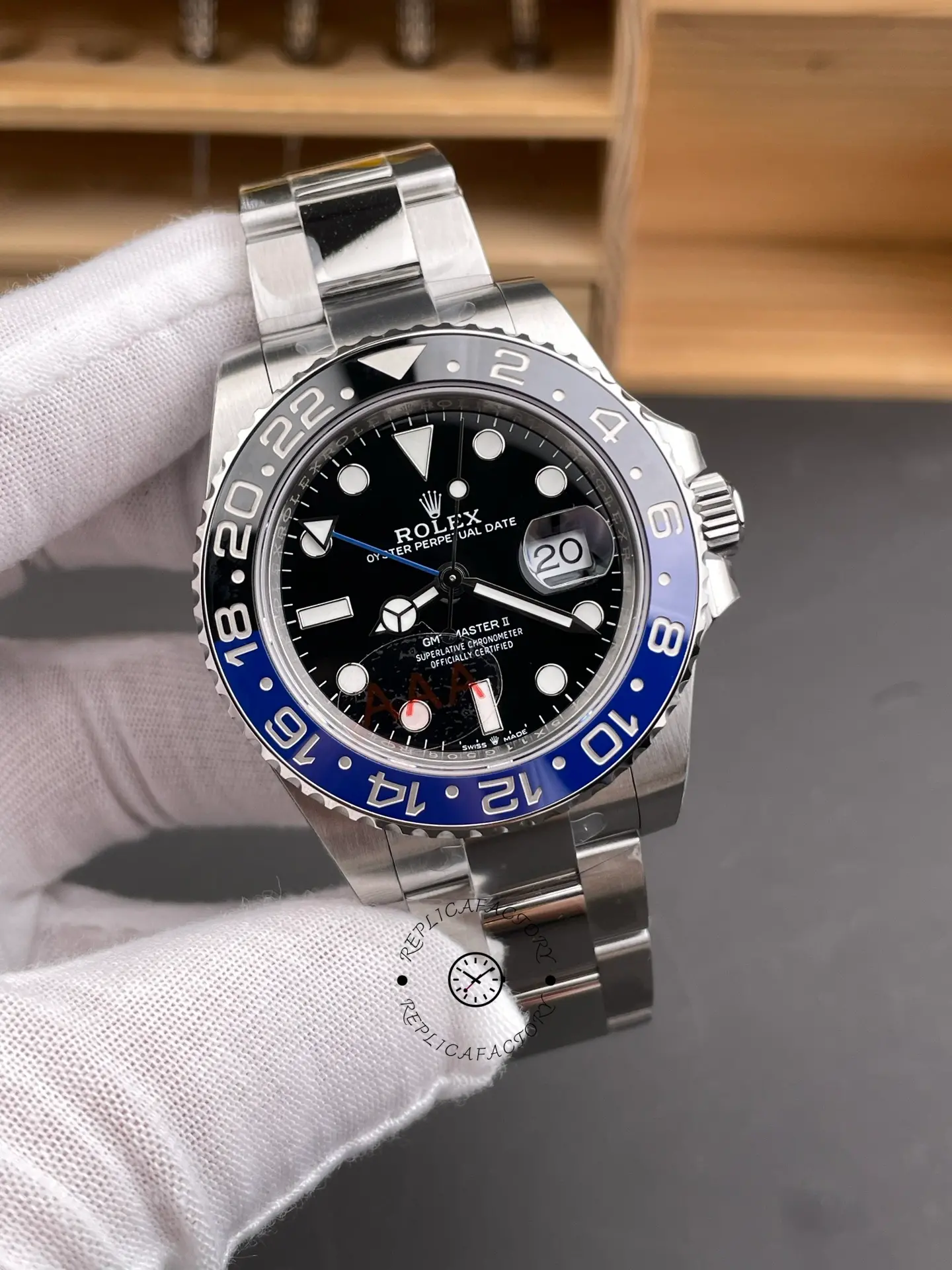 Angled front view of Rolex GMT-Master II 116710BLNR showing black dial, date magnifier, and blue-black bezel.