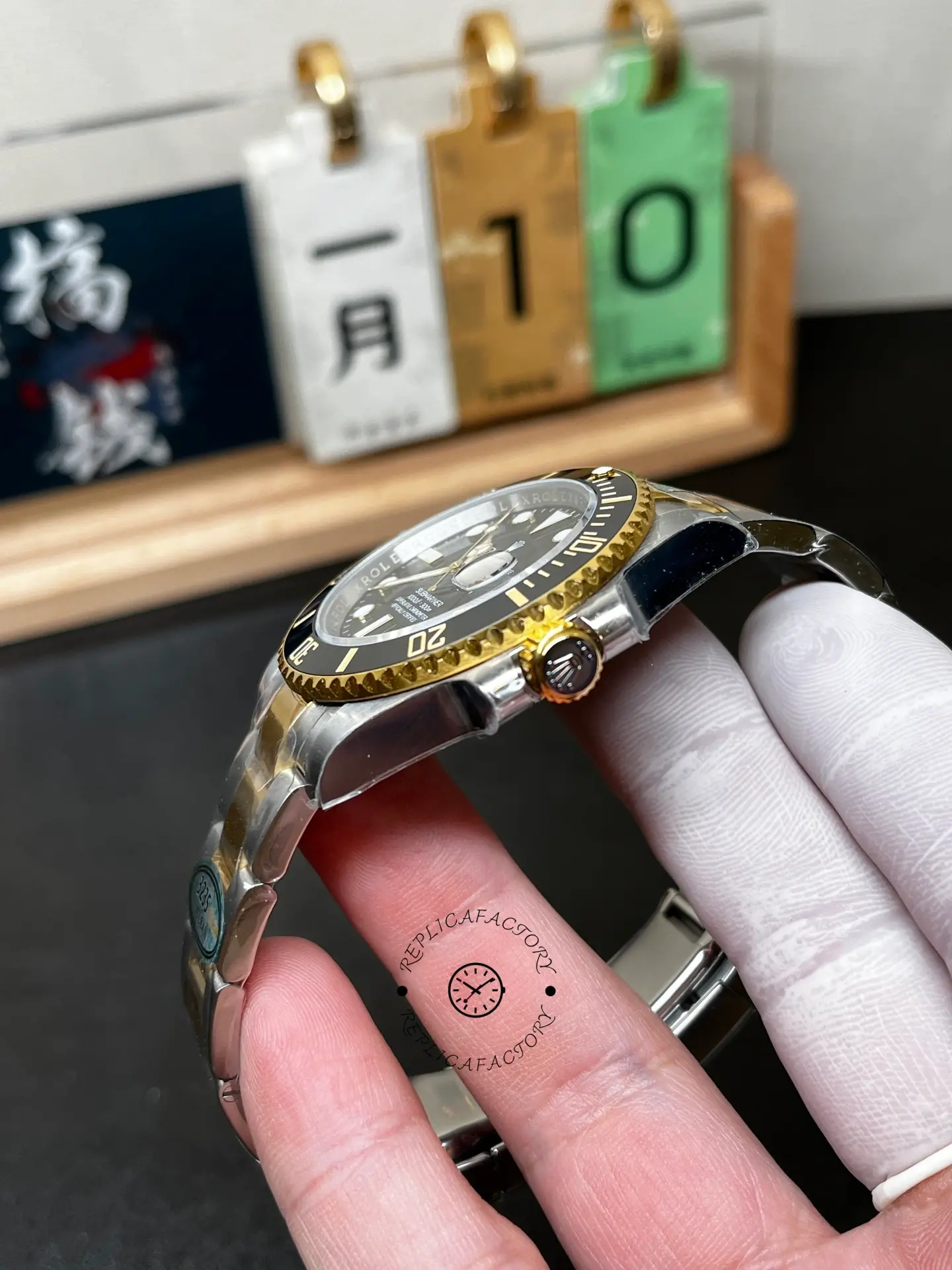 Side profile of Rolex Submariner 126613LN-0002 replica showing black bezel, gold crown and case shape.