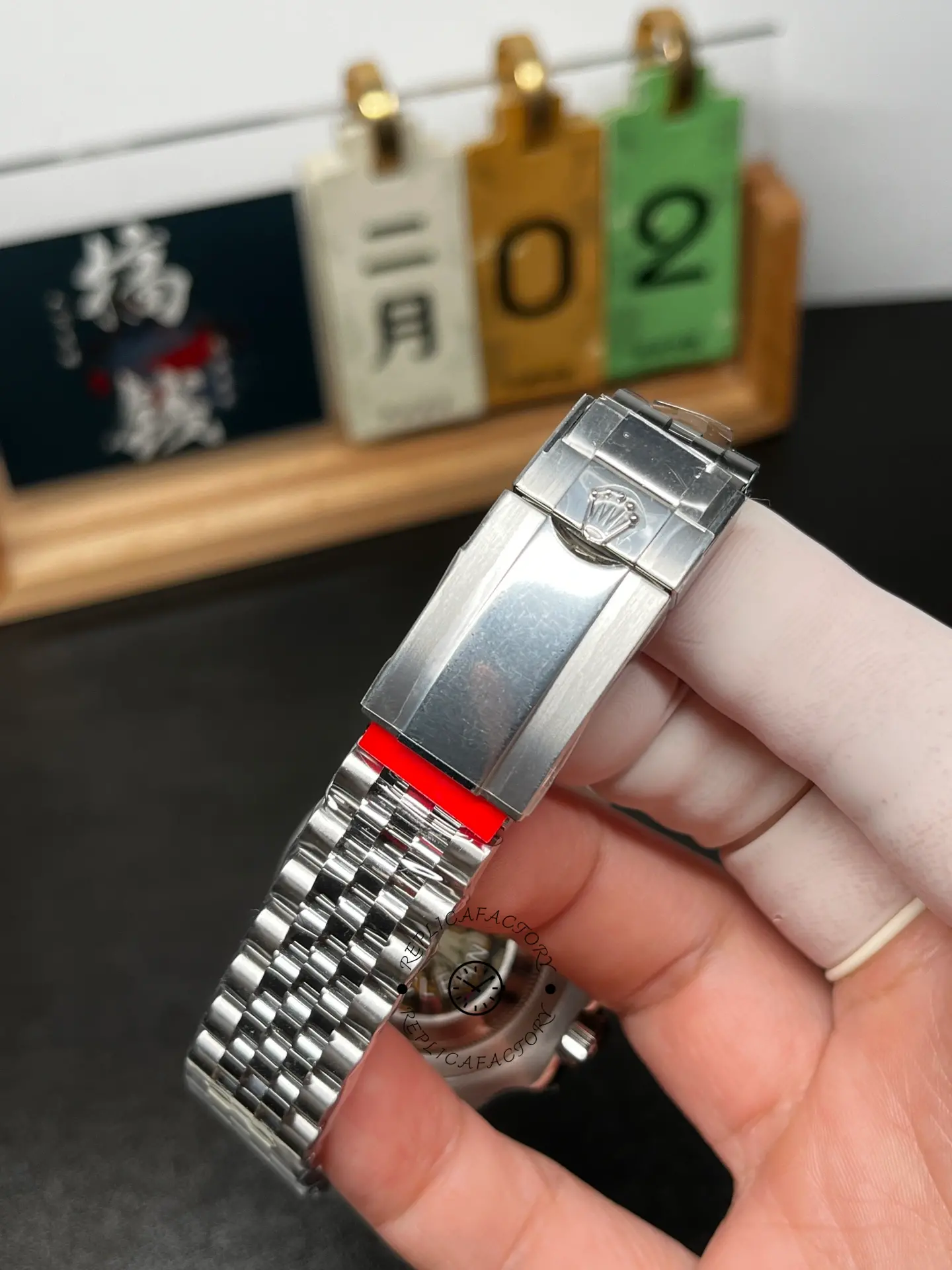 Clasp close-up of Rolex GMT-Master II M126710GRNR-0003 showing folding clasp with Rolex crown logo.