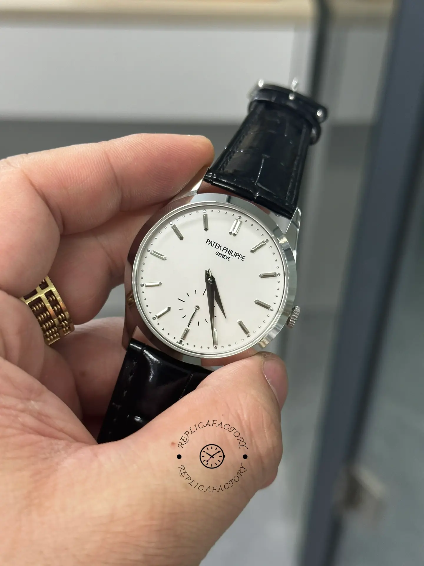 Hand-held front view of Patek Philippe Calatrava 5196G-001 showing small seconds subdial and minute track.