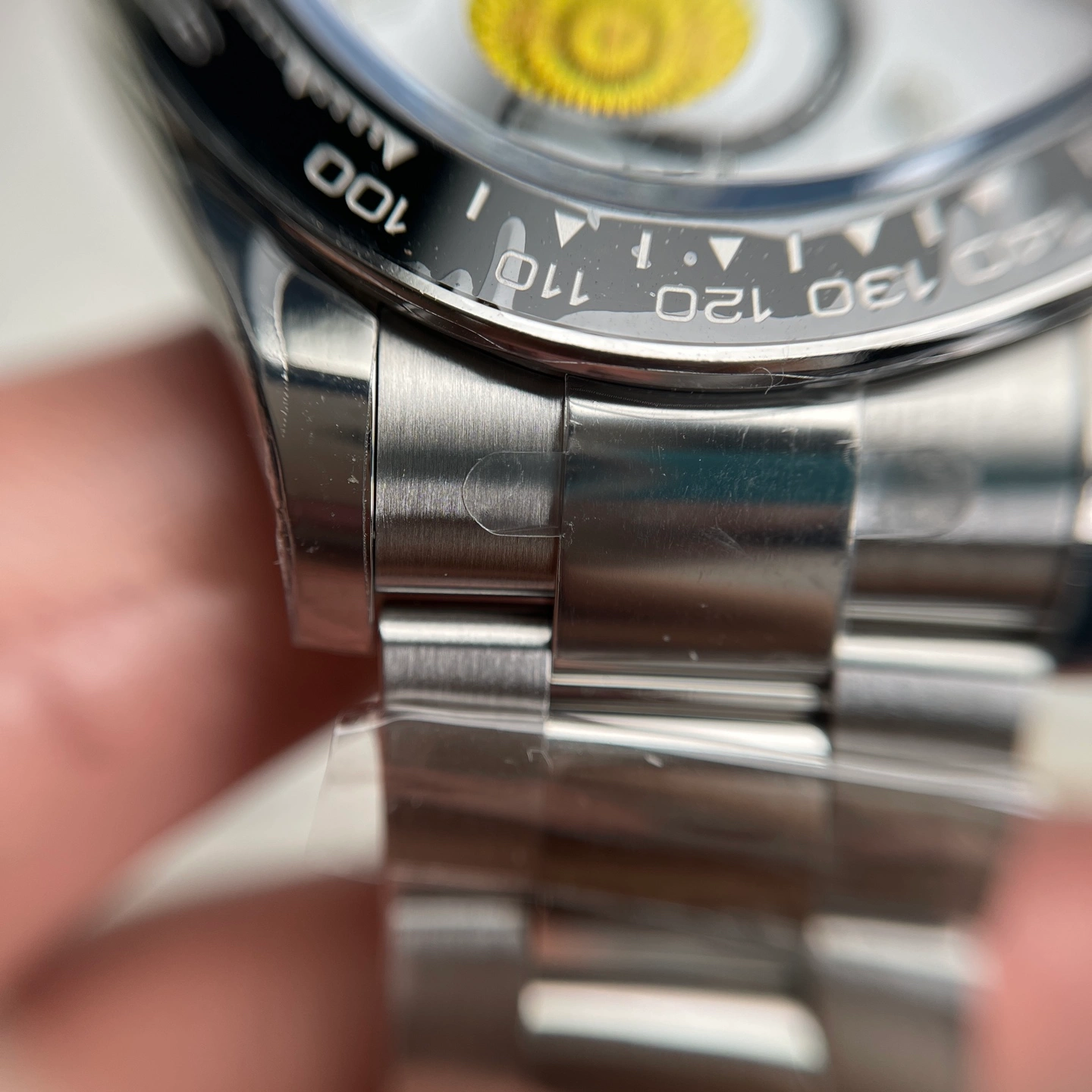 Close-up of a stainless steel watch case and bracelet connection