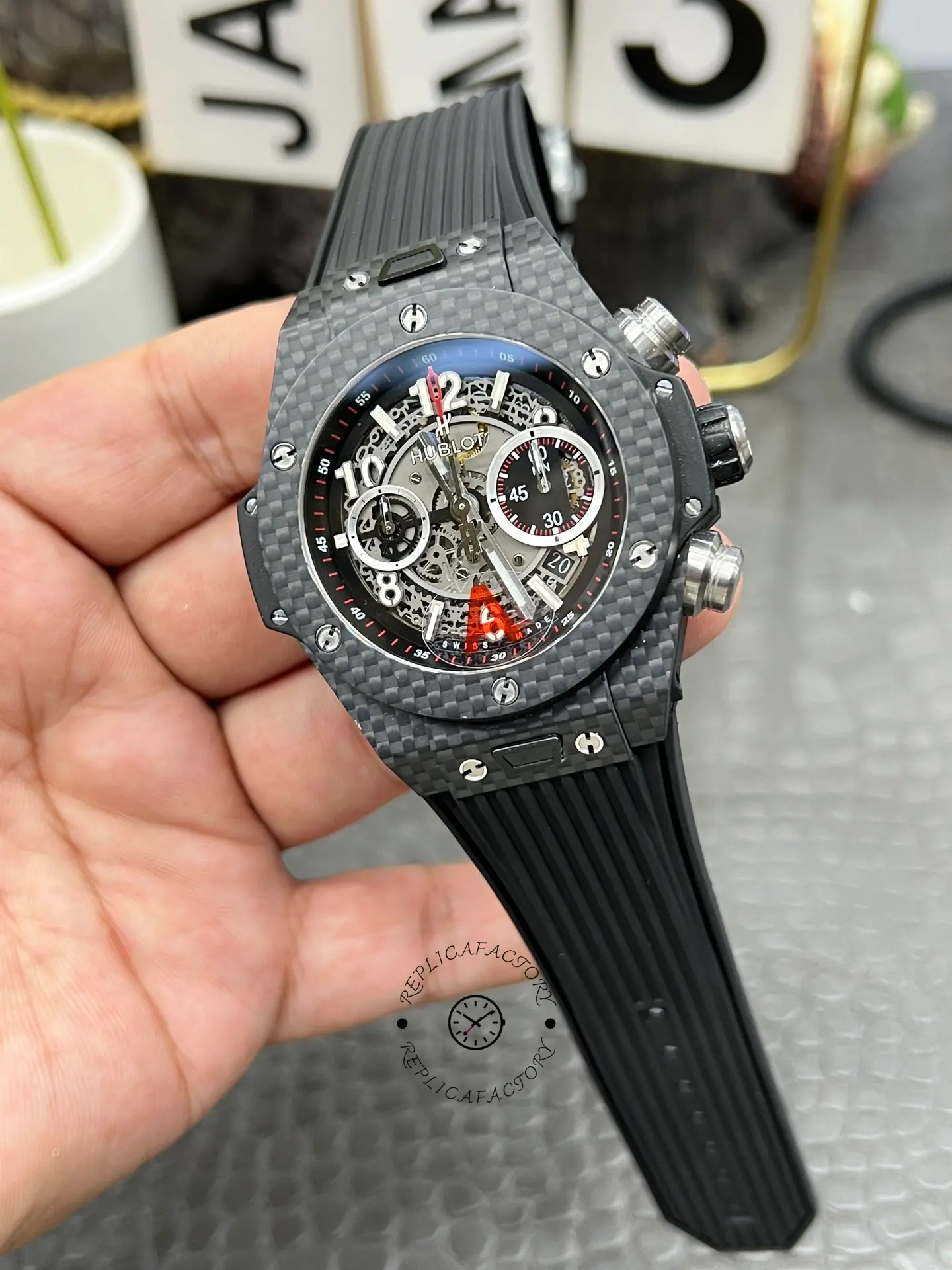 Hublot Big Bang UNICO 411.QX.1170.RX hand-held front, red seconds hand and subdial details.