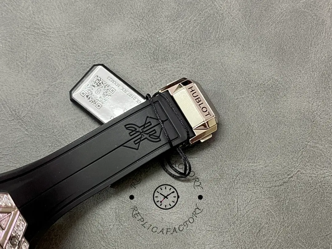 Clasp close-up of Hublot 648.NX.0107.RX.1604.MXM23 showing Hublot clasp engraving and strap end hardware.