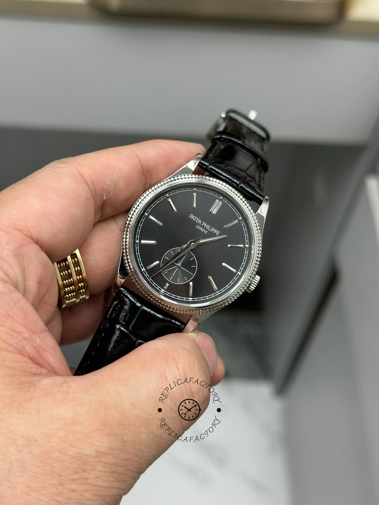 Hand-held close-up of Patek Philippe Calatrava 6119G-001 highlighting small seconds and minute track.