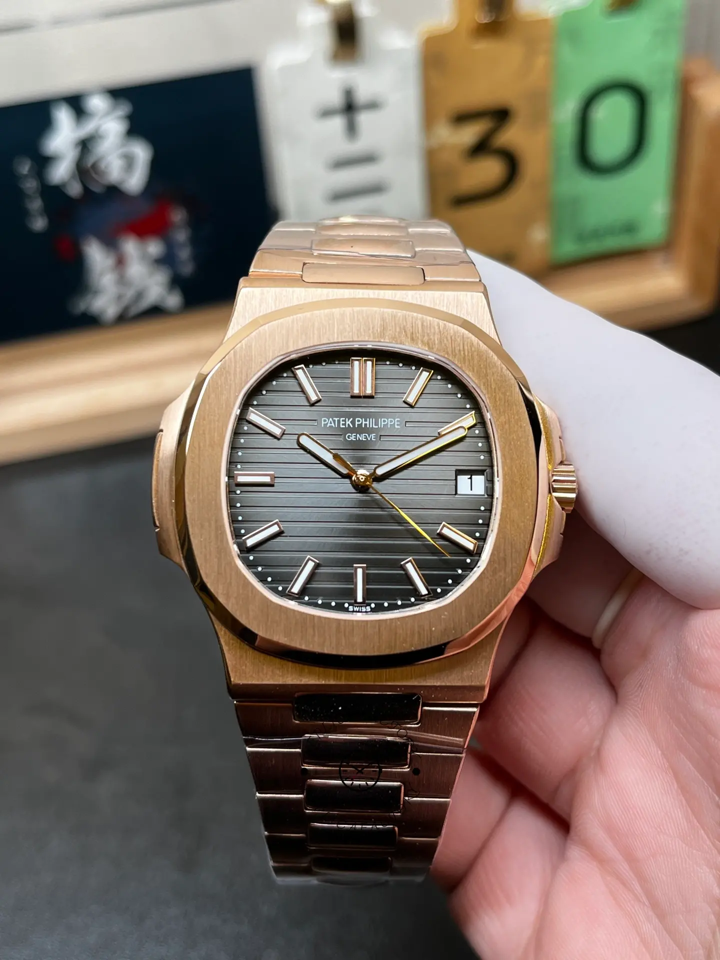 Front close-up of Patek Philippe Nautilus 5711/1R-001 showing applied markers and date window.
