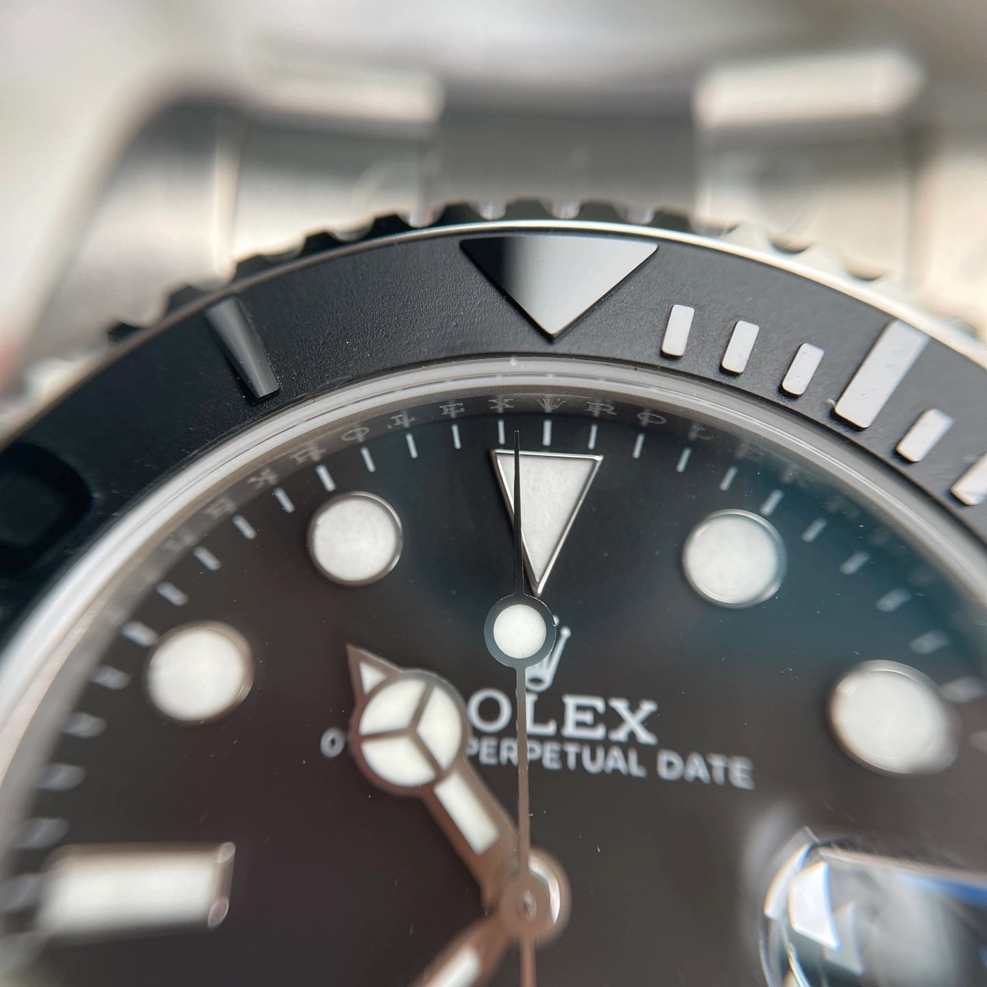 Close-up of a titanium watch case and bracelet connection with brushed finishing