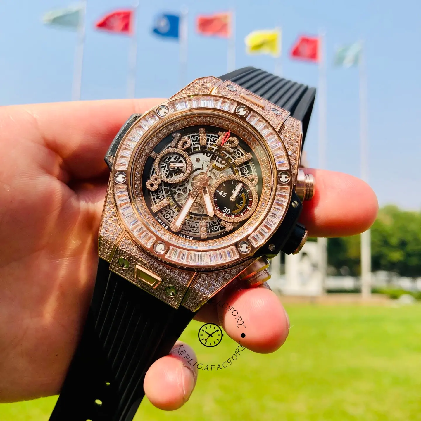 Hand-held close-up of Hublot 421.OX.1180.RX.0904 highlighting the baguette bezel and pavé rose gold-tone case.