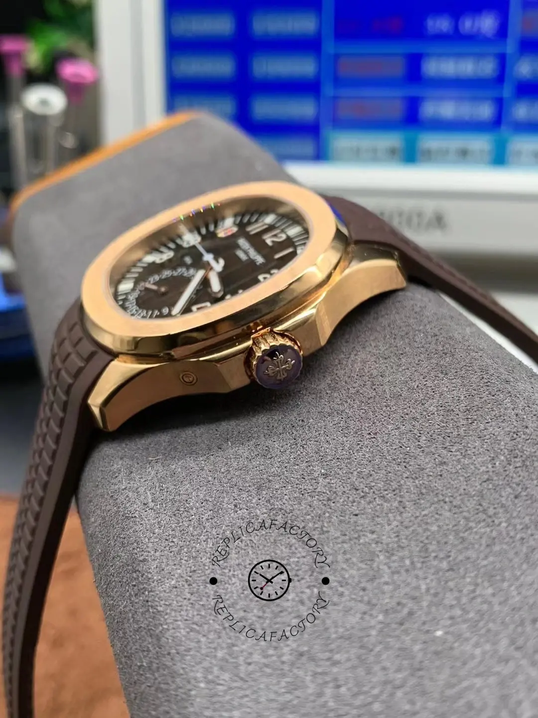 Low-angle side view of the Patek Philippe Aquanaut 5164R-001 showing polished rose-gold case edge and crown.