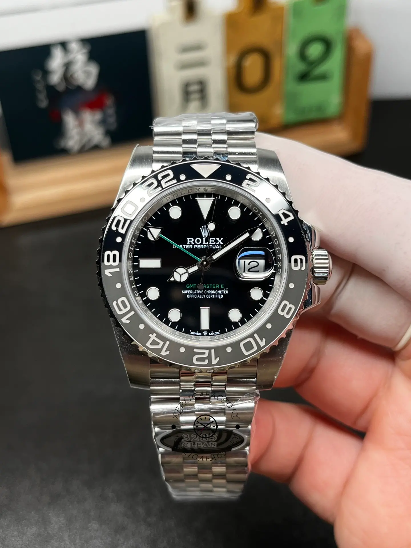 Front view of Rolex GMT-Master II M126710GRNR-0003, black dial with green GMT hand and date at 3 o’clock.