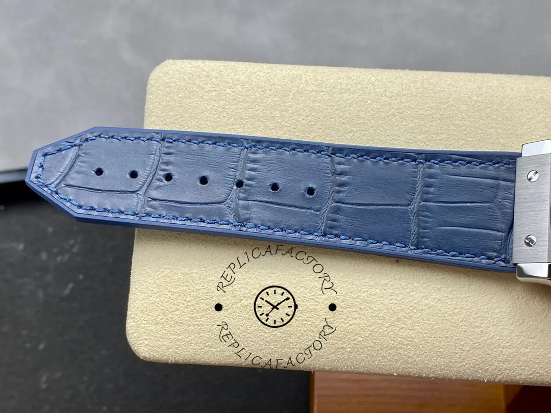 Strap holes detail of Hublot Classic Fusion 542.NX.7170.LR showing blue leather strap perforations.