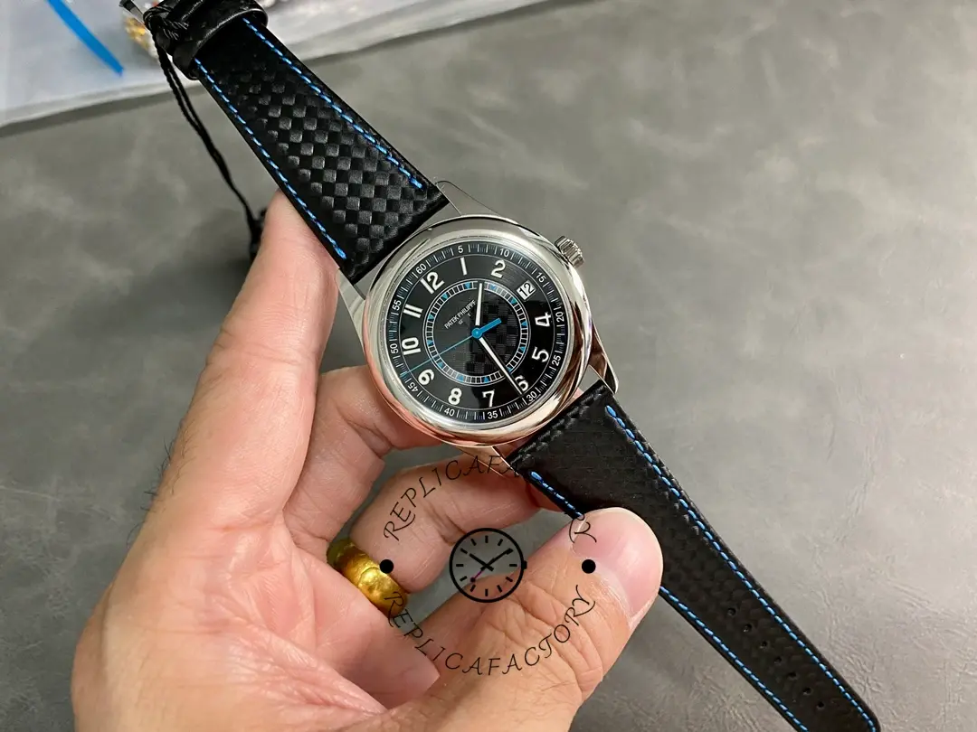 Full watch in hand: Patek Philippe Calatrava 6007G-011 showing strap texture and case shape.