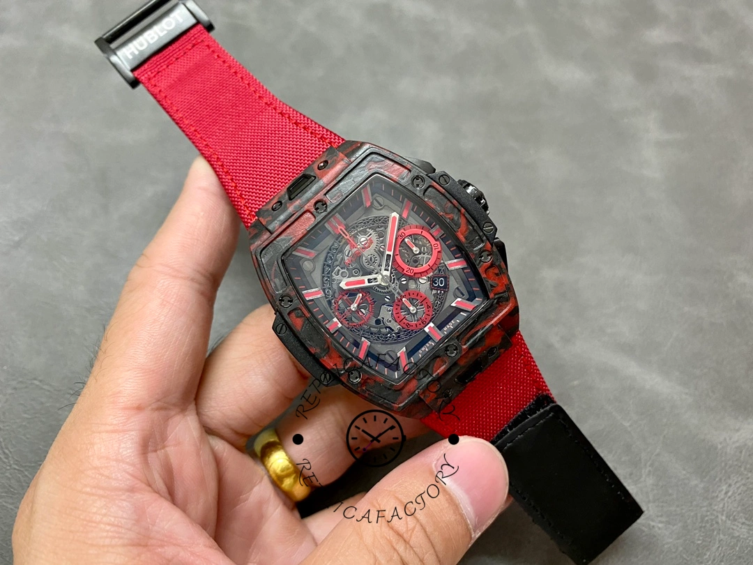 Hublot Big Bang 642.QV.0113.NR.CNY21 hand-held shot with red strap showing full dial layout.