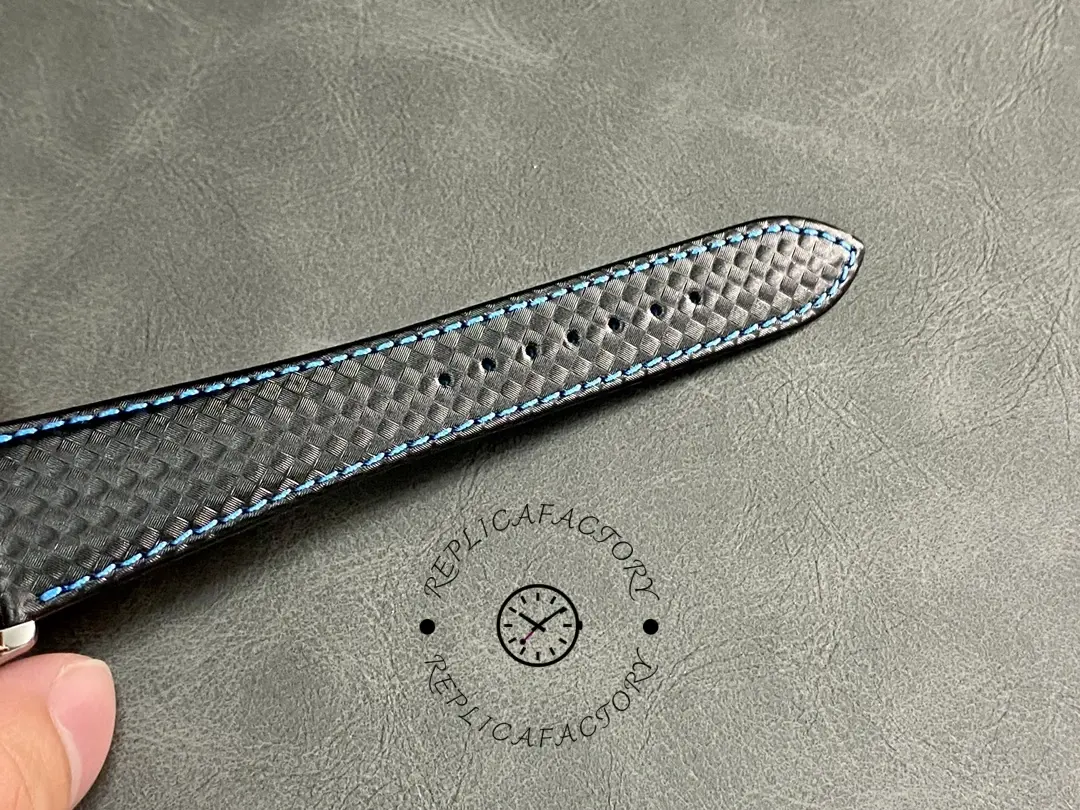 Strap end close-up of the Patek Philippe Calatrava 6007G-011, showing fabric weave and stitching.