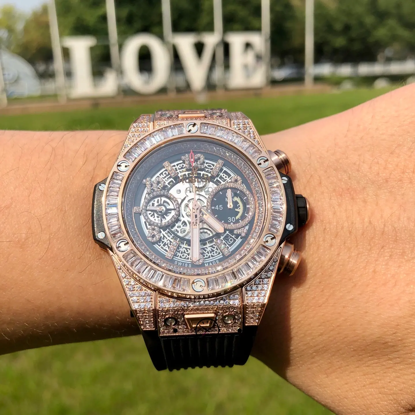 Straight-on wrist view of Hublot 421.OX.1180.RX.0904 with baguette bezel and pavé case details in daylight.