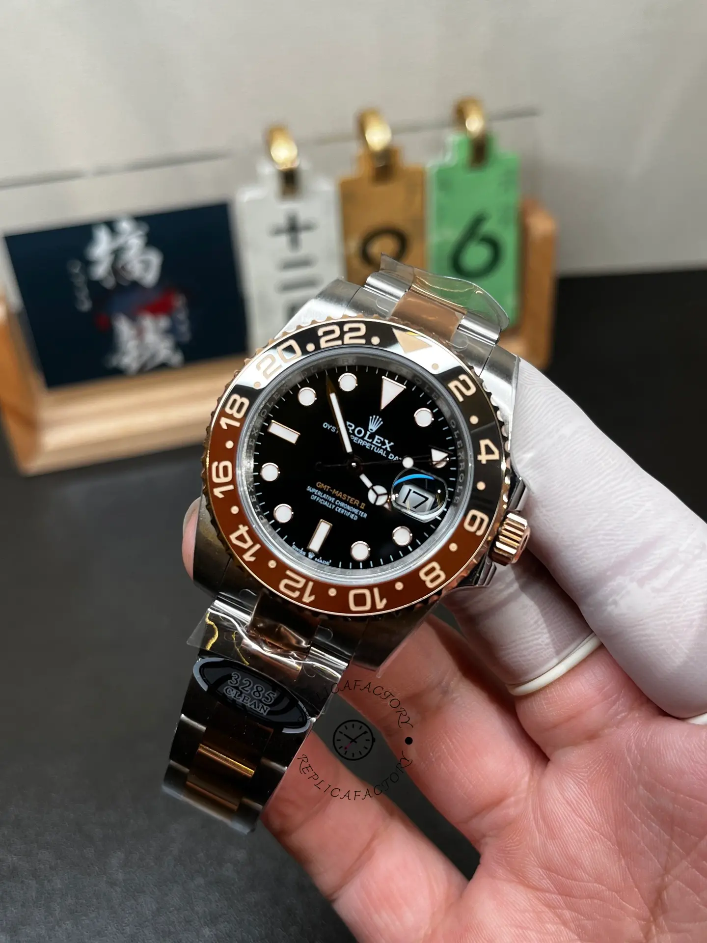 Angled hand-held front view of Rolex 126711CHNR with black dial and black brown ceramic-style bezel.