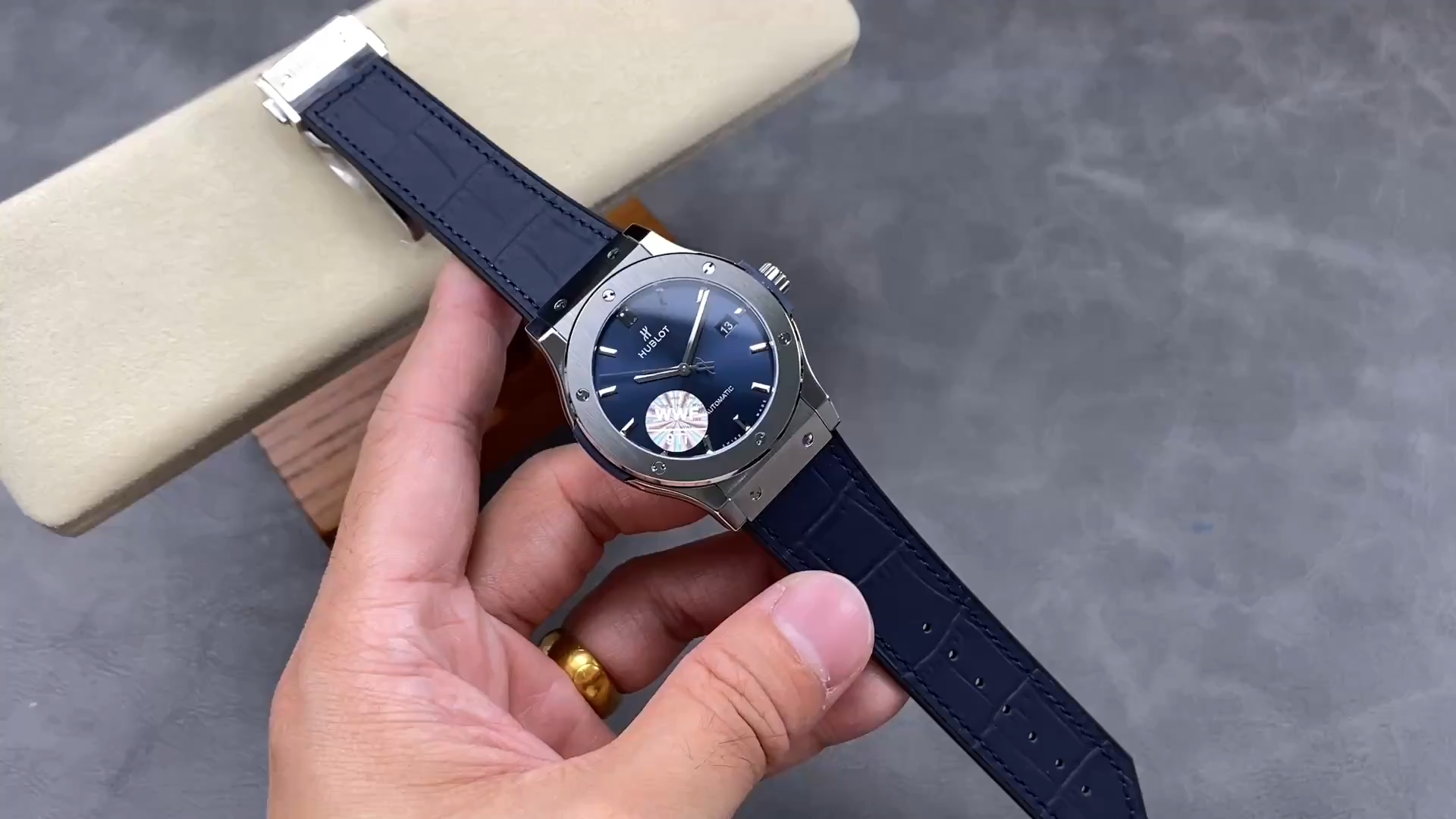 Strap in hand: Hublot Classic Fusion 542.NX.7170.LR blue leather strap shown from top side. - Video